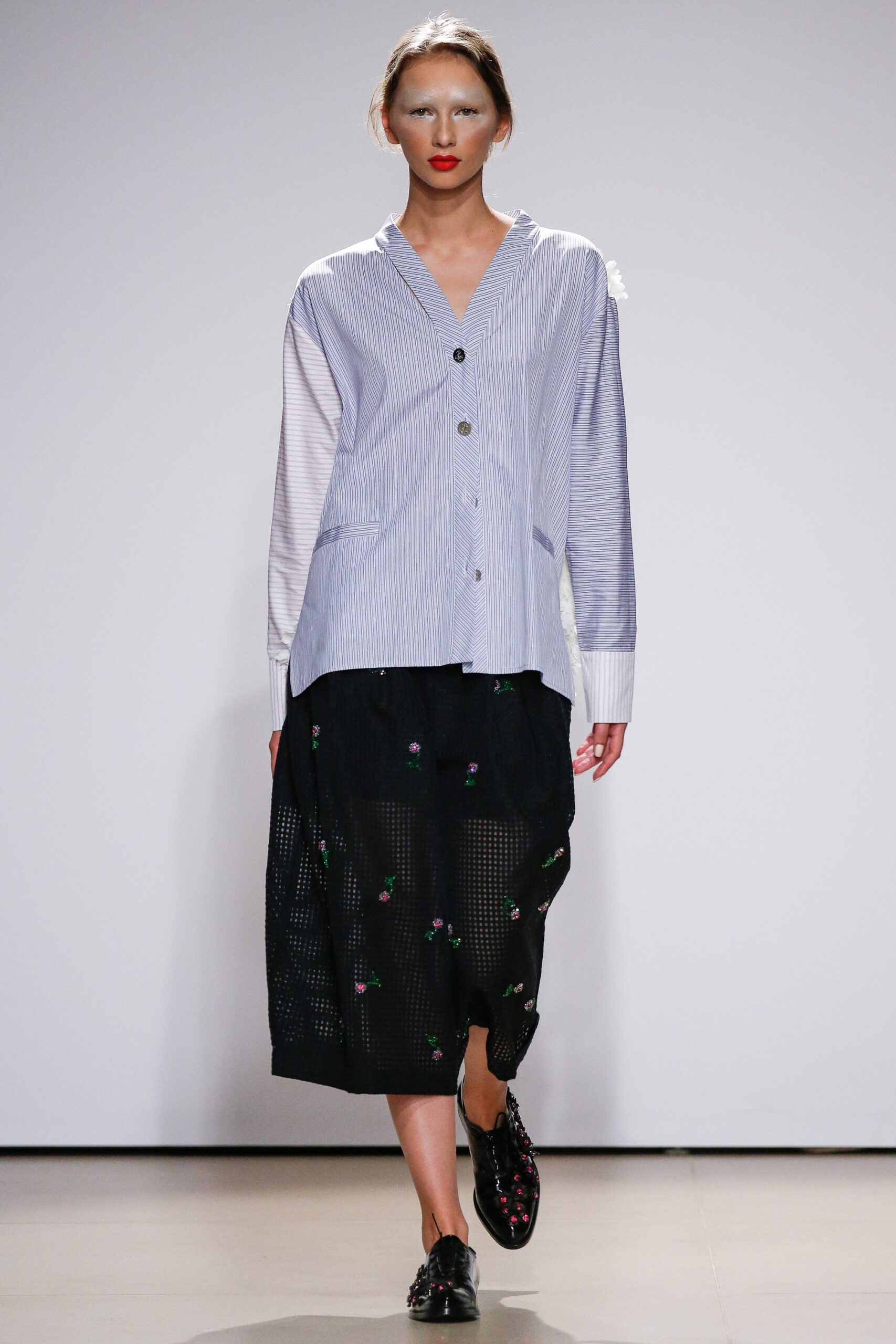blue striped shirt and black pleated skirt