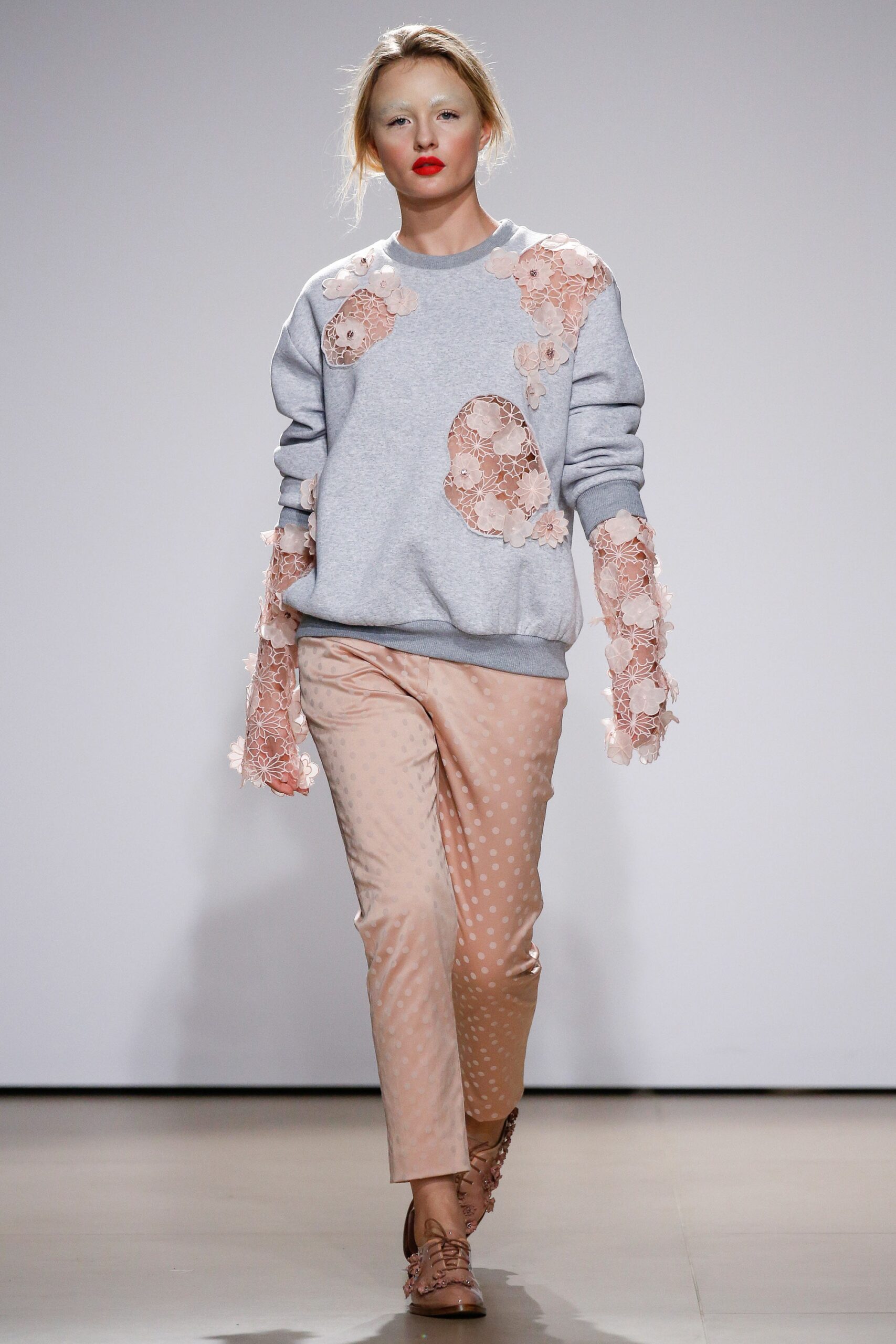 gray embroidered sweater with pink pants