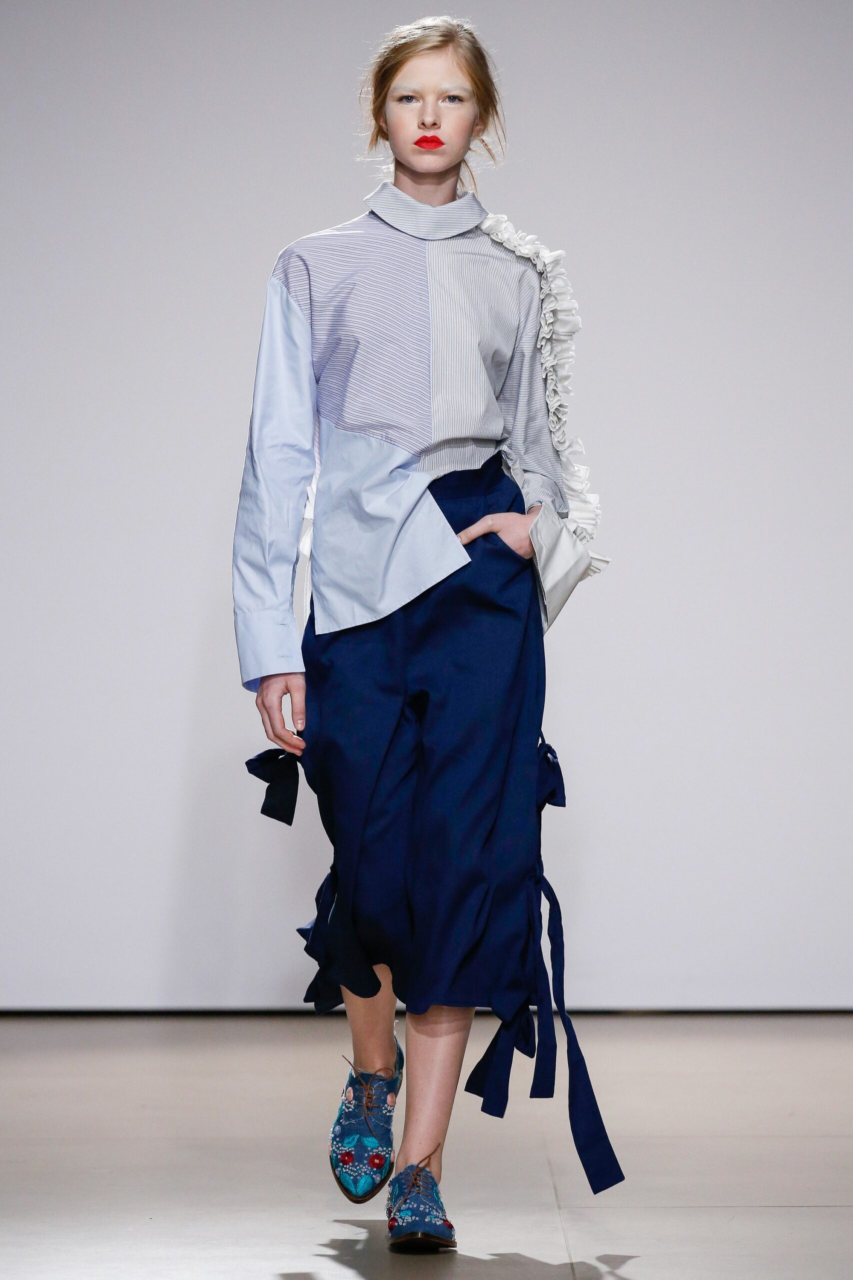 blue and white ruffled shirt with navy pants