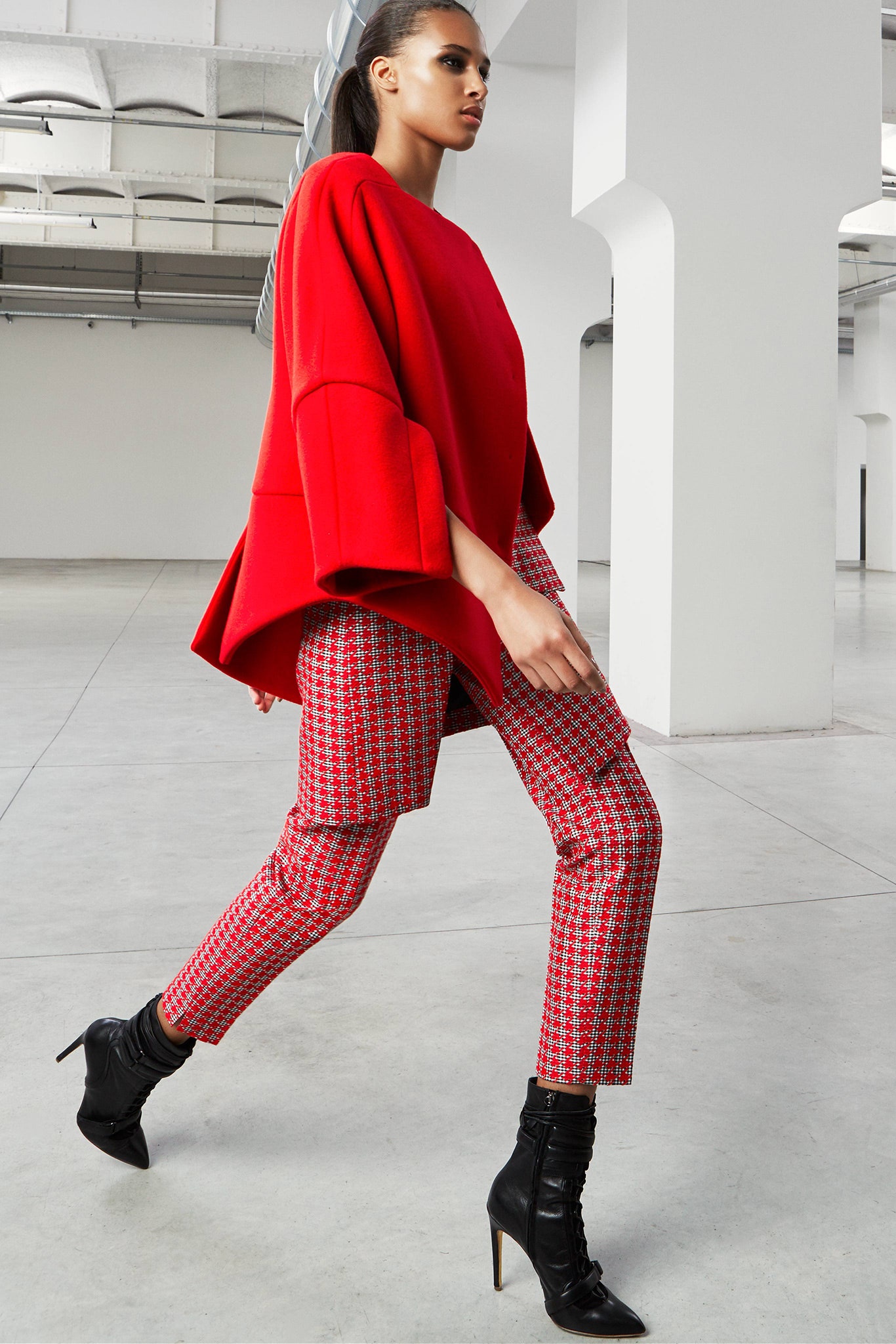 red oversized top with patterned pants