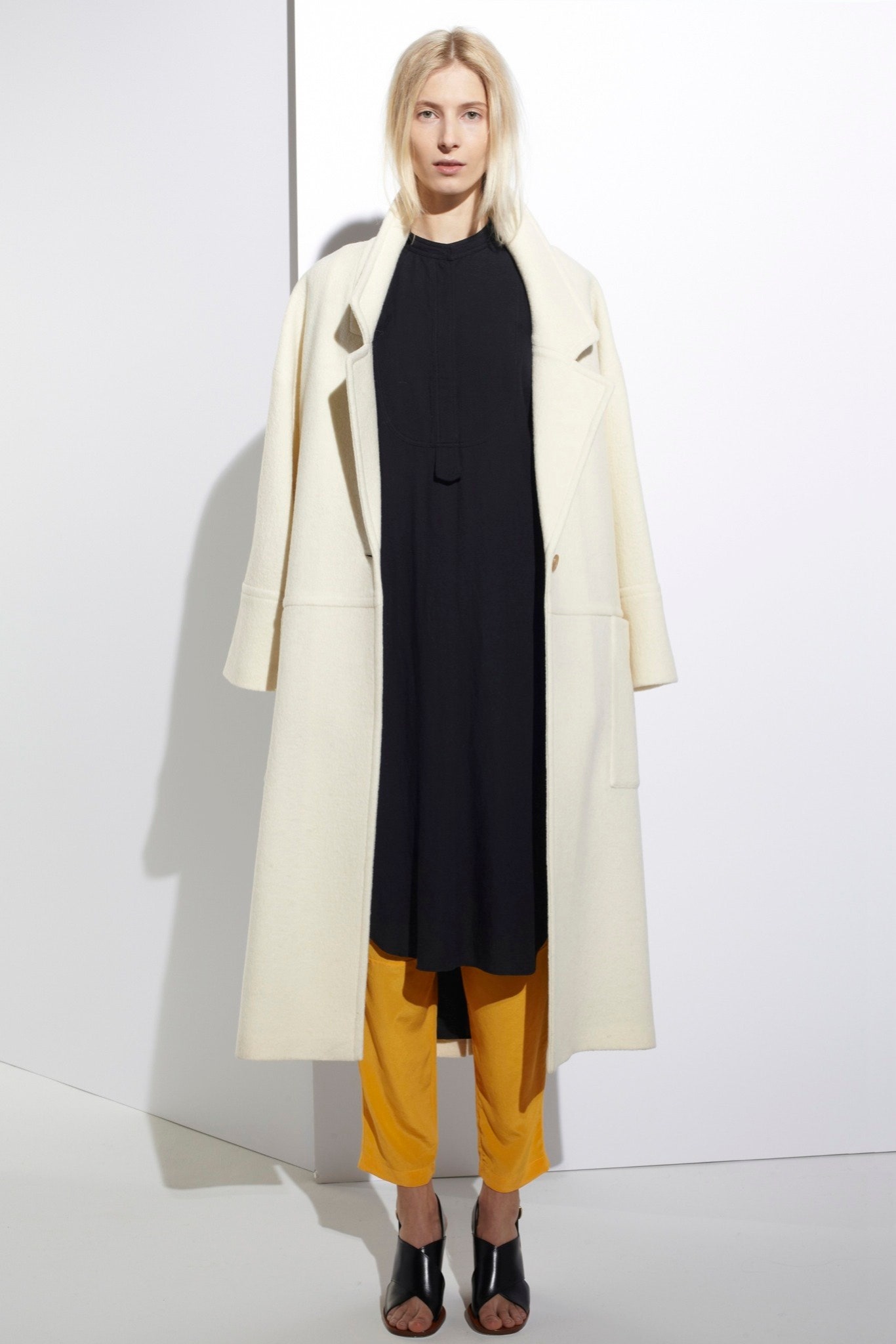 white wool coat black dress yellow pants