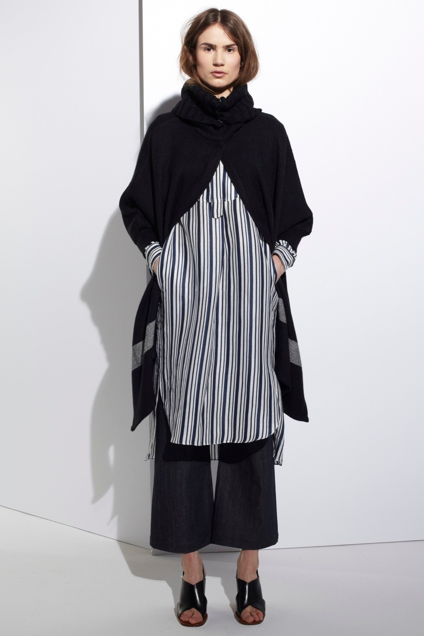 black poncho and striped shirt-dress