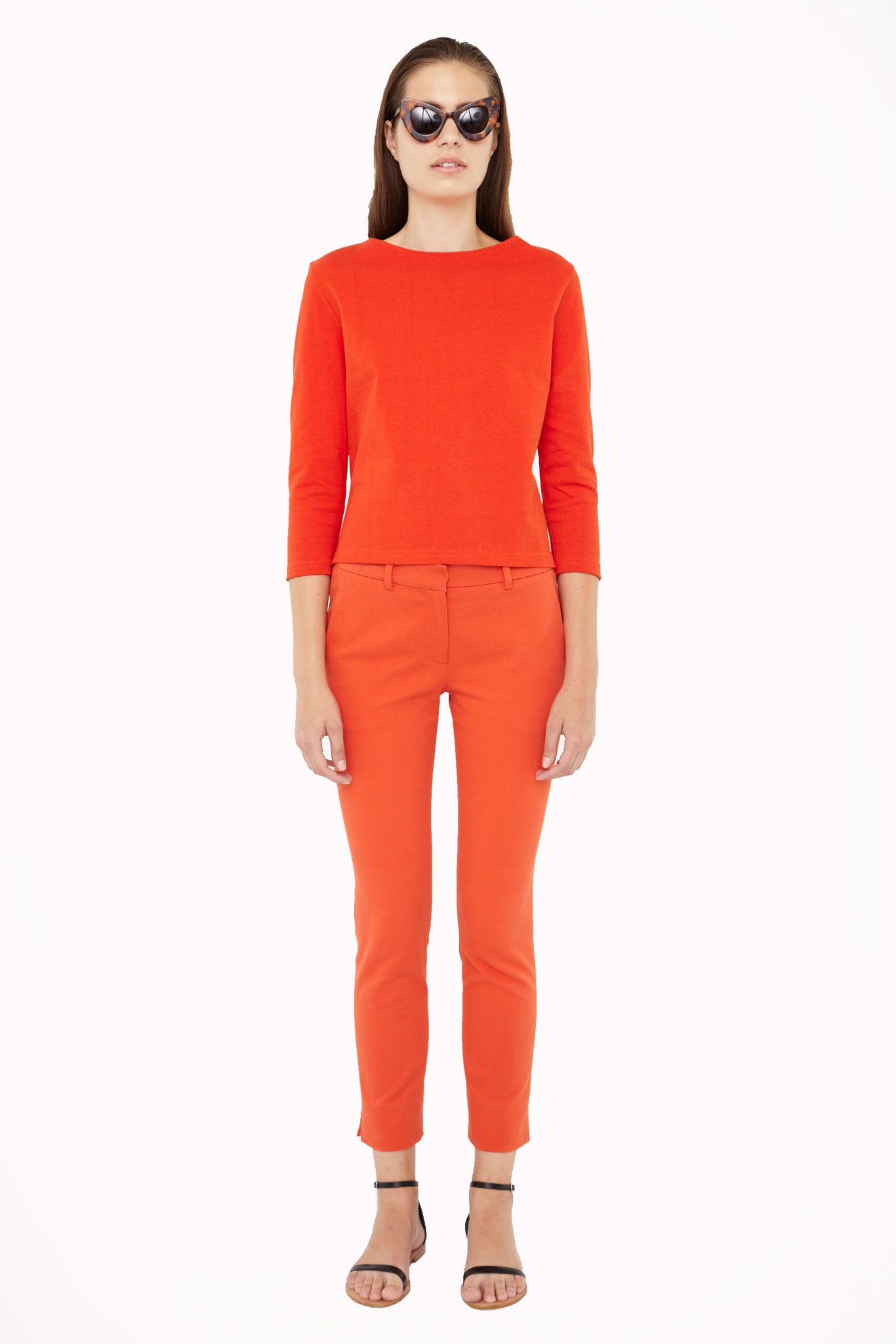 red fitted top with orange pants