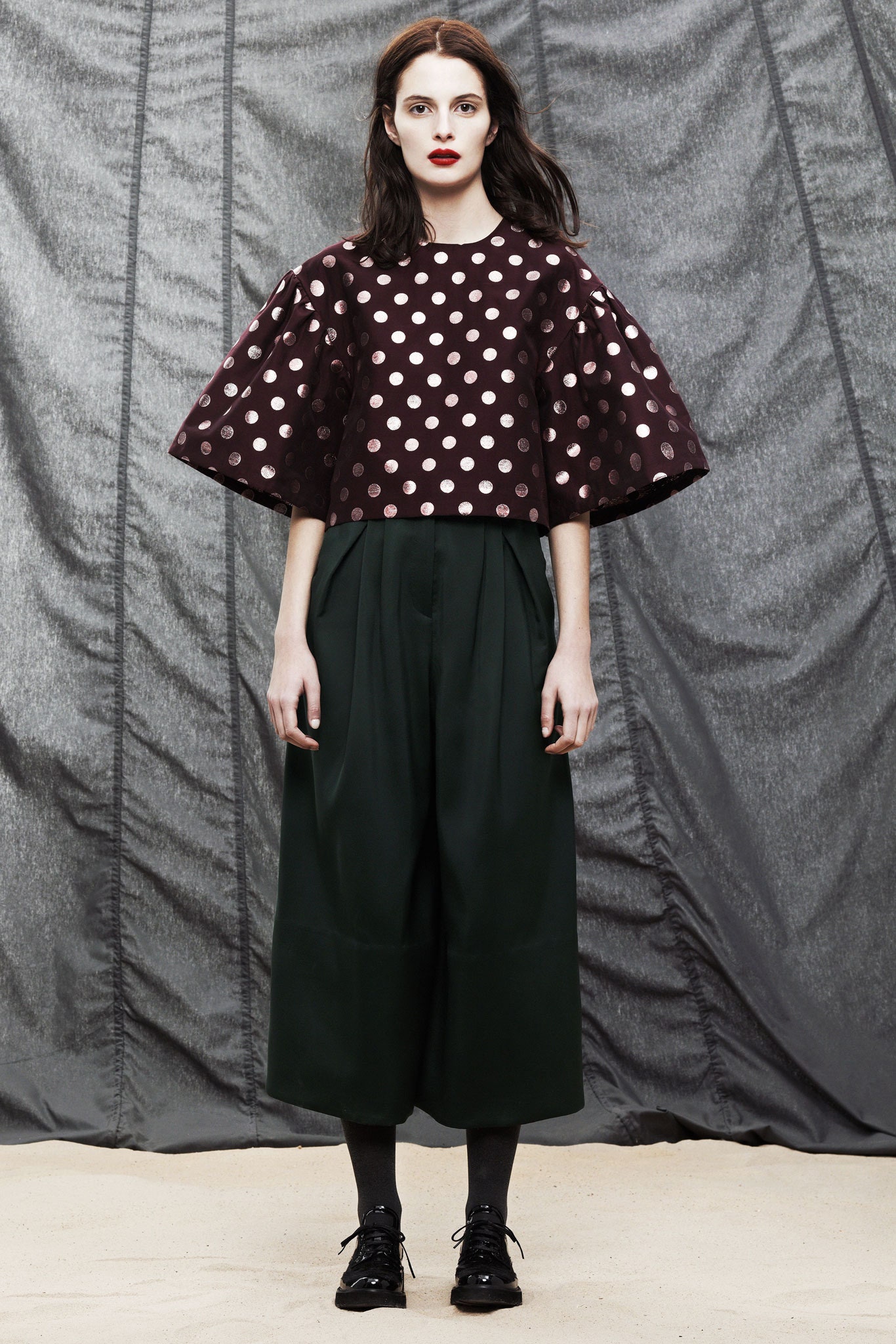 burgundy polka-dot top with green pants