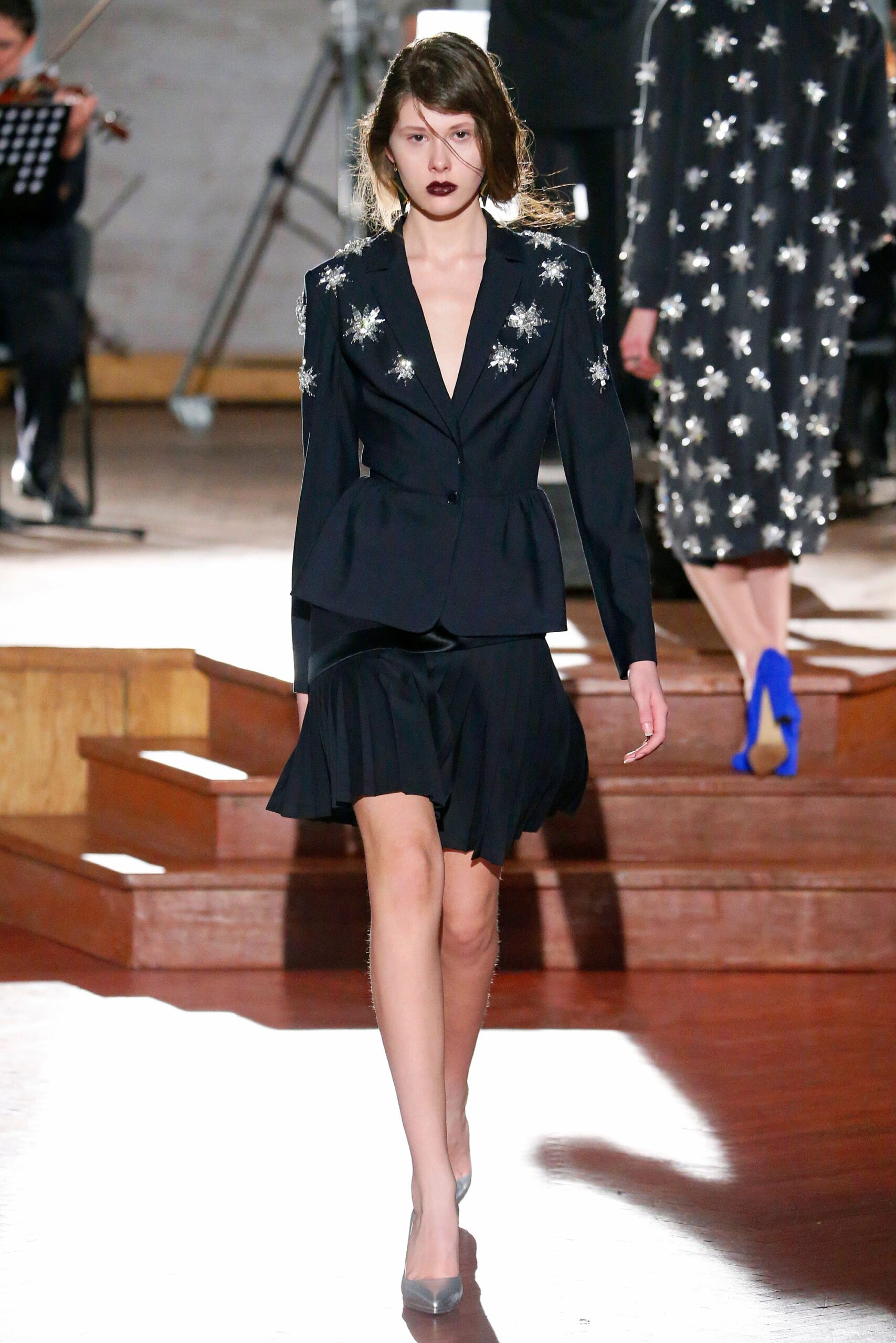 black tailored blazer and pleated skirt