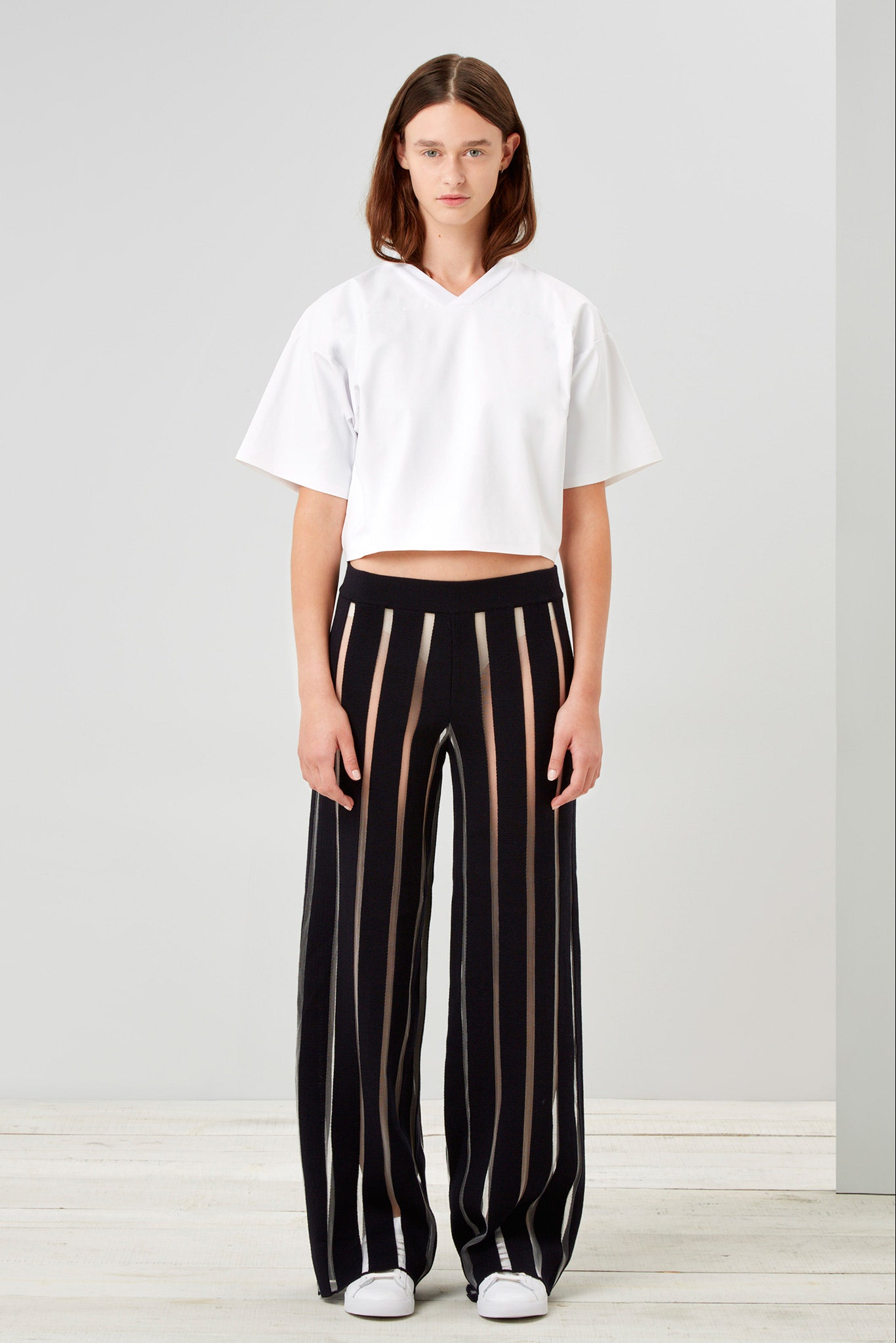white cropped top and black striped pants