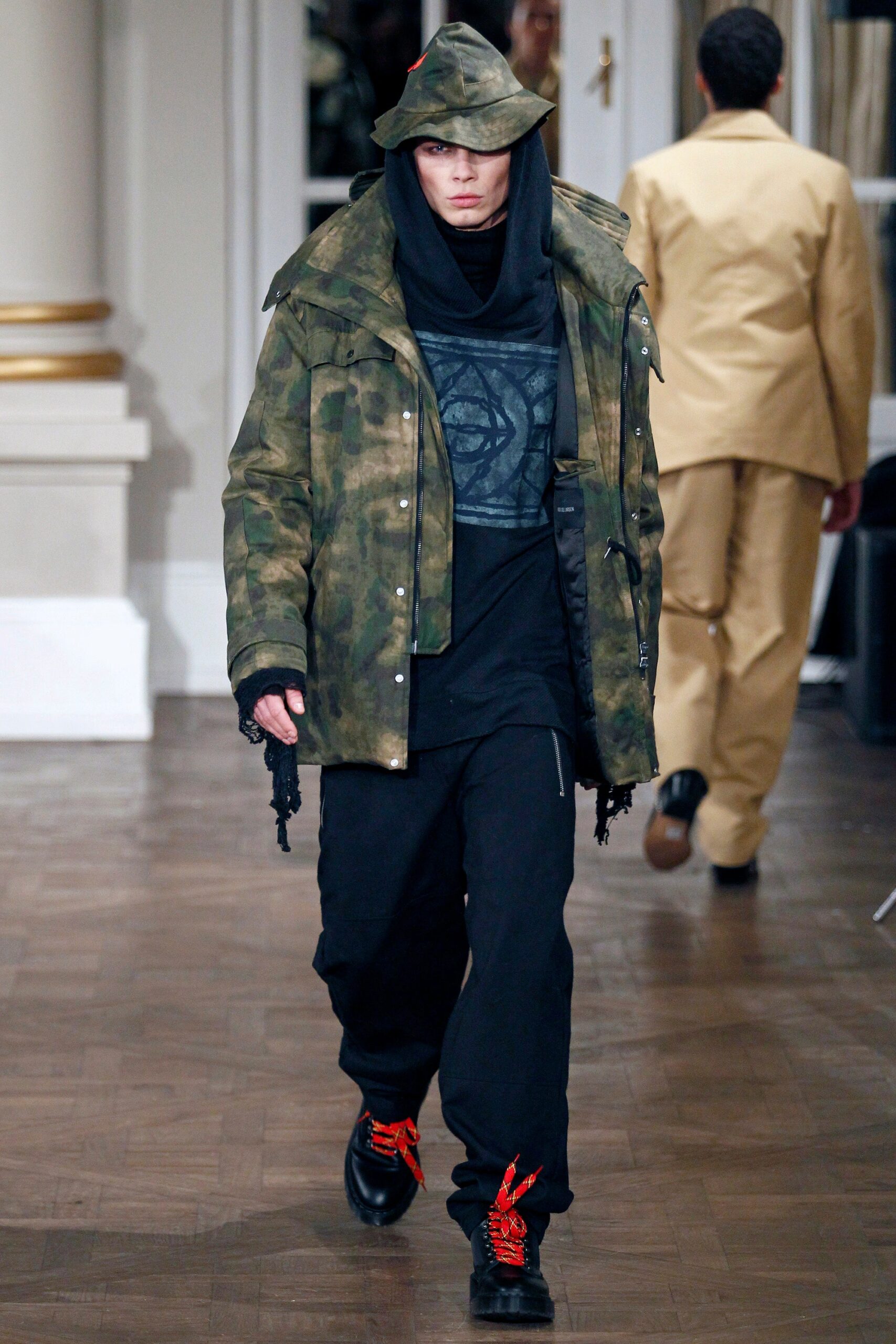 camouflage jacket with black top and pants
