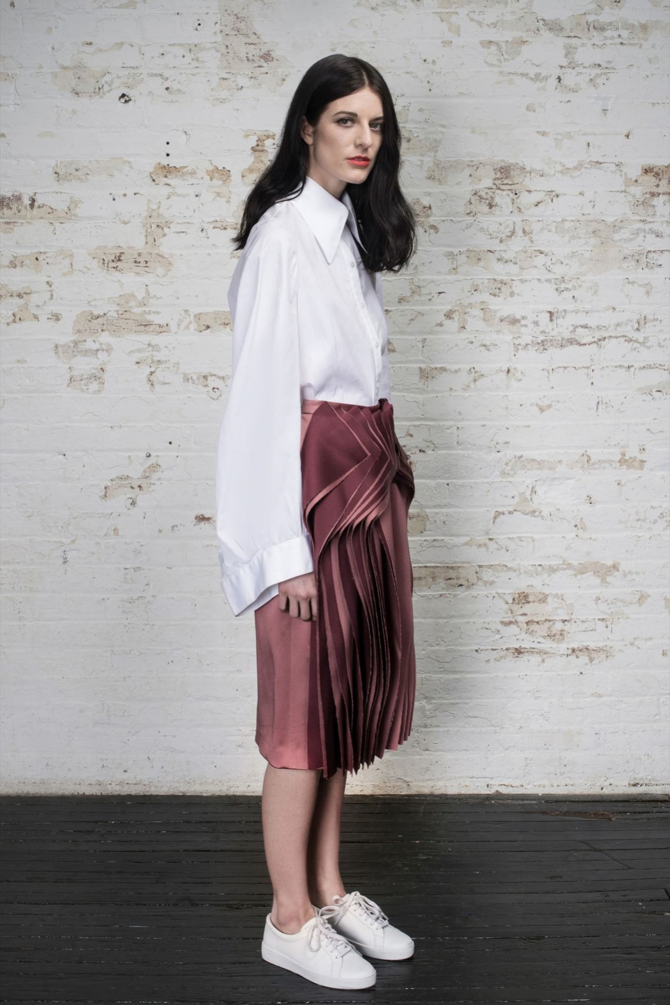 white relaxed shirt with pink pleated skirt