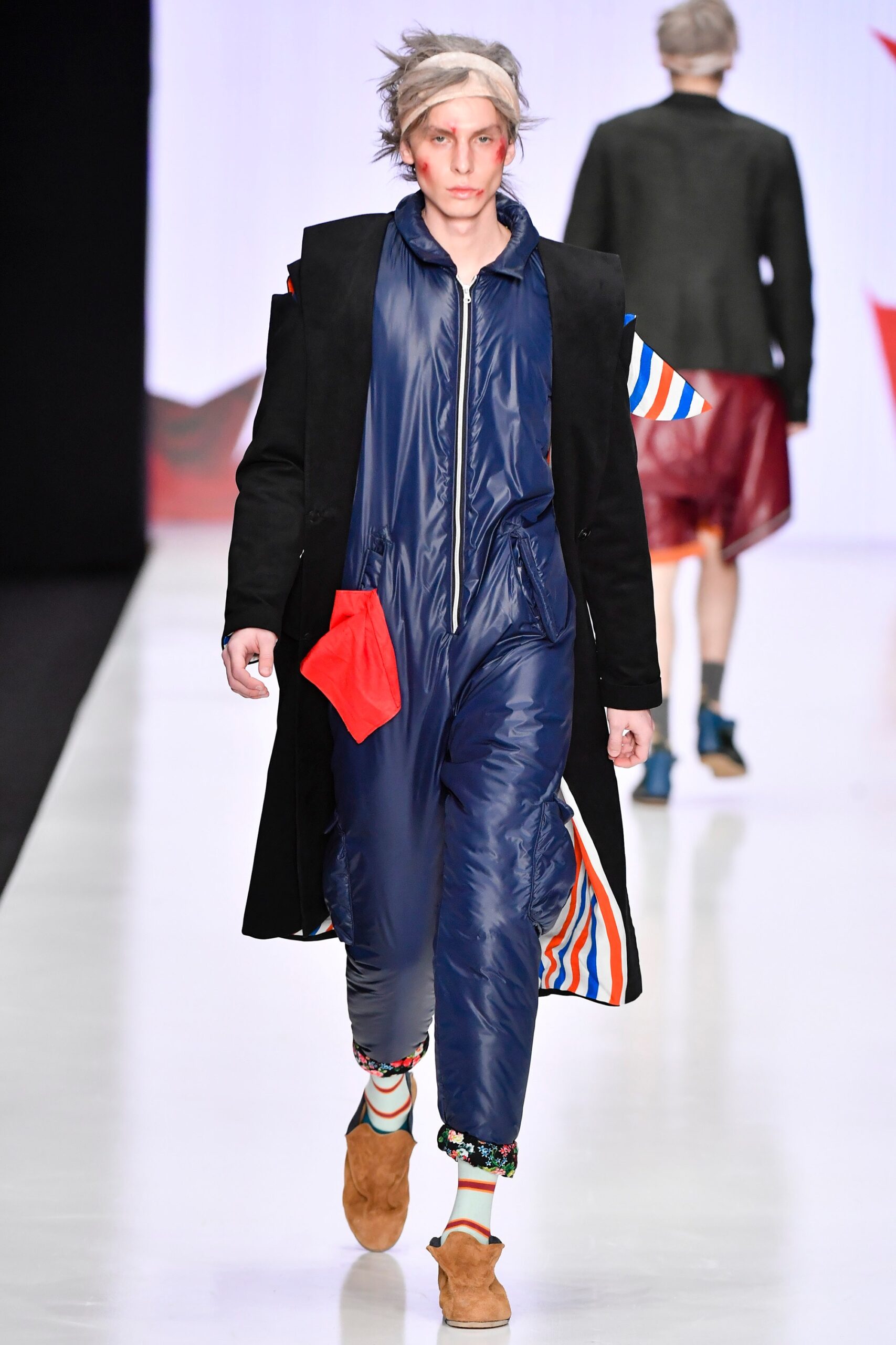 blue fitted jumpsuit with black coat