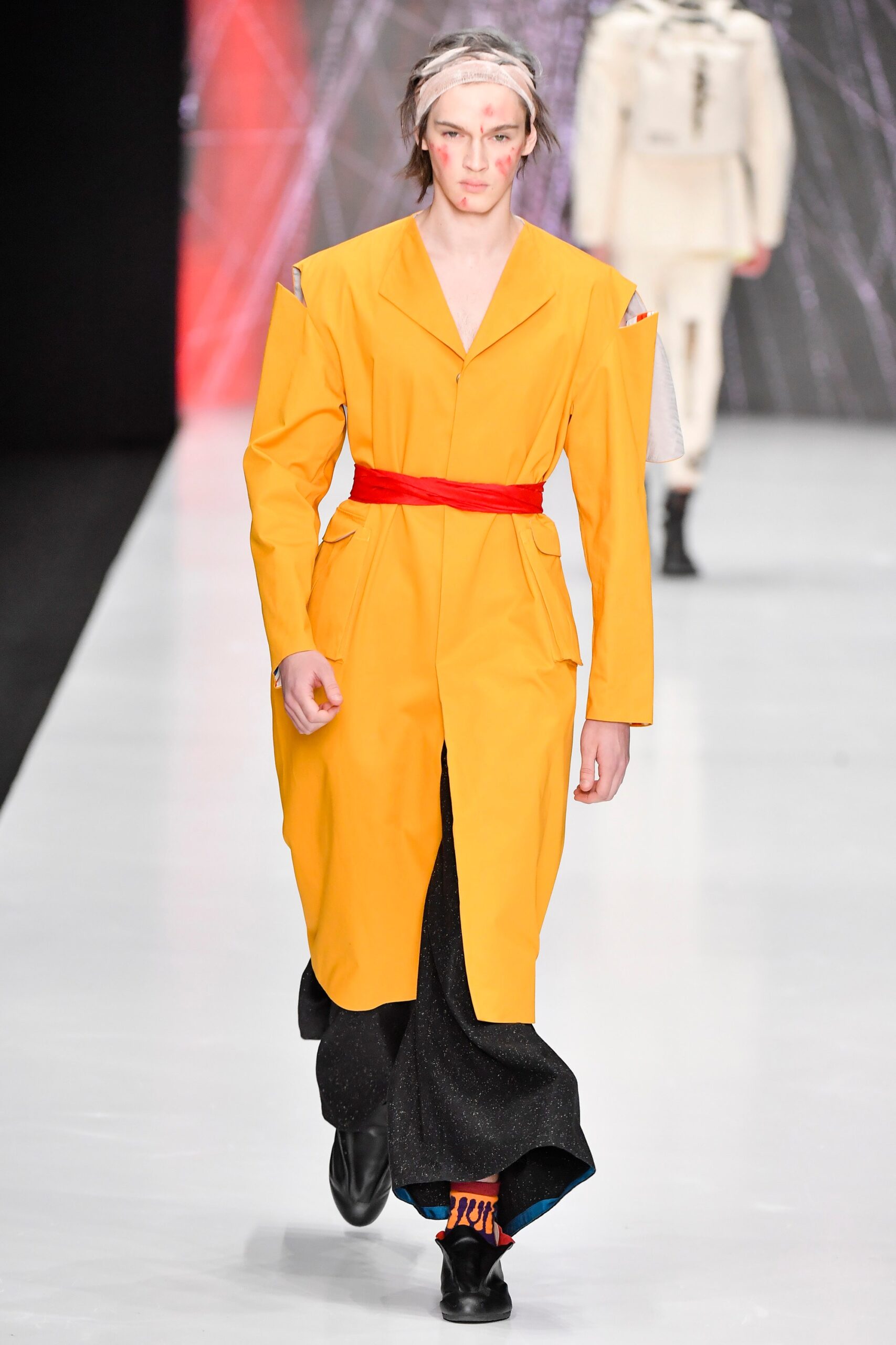 yellow belted coat with black pants