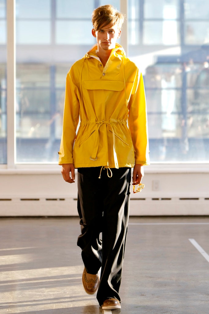 yellow hooded jacket with black pants