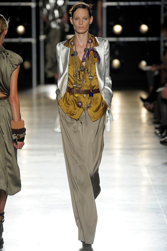 silver blazer gold top beige pants