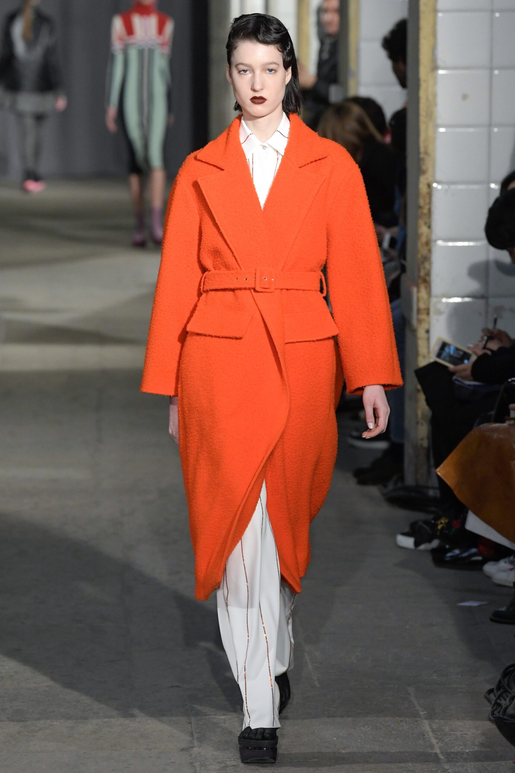 orange wool belted coat with white pants