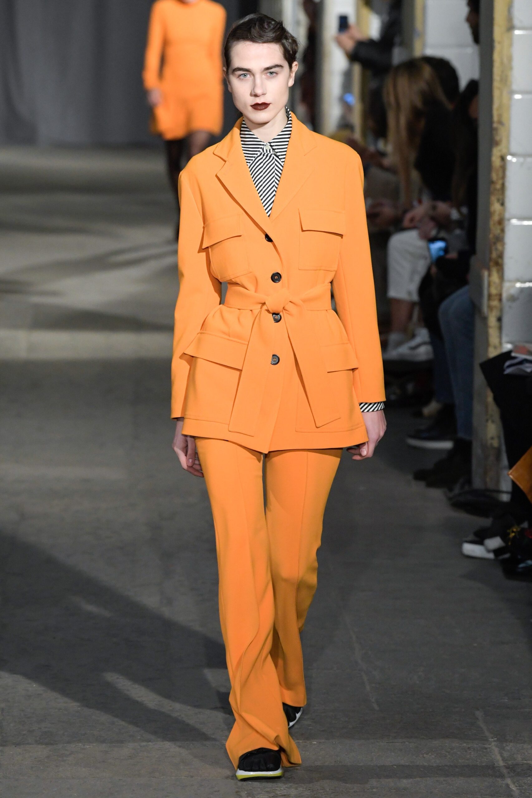 orange tailored suit with striped shirt