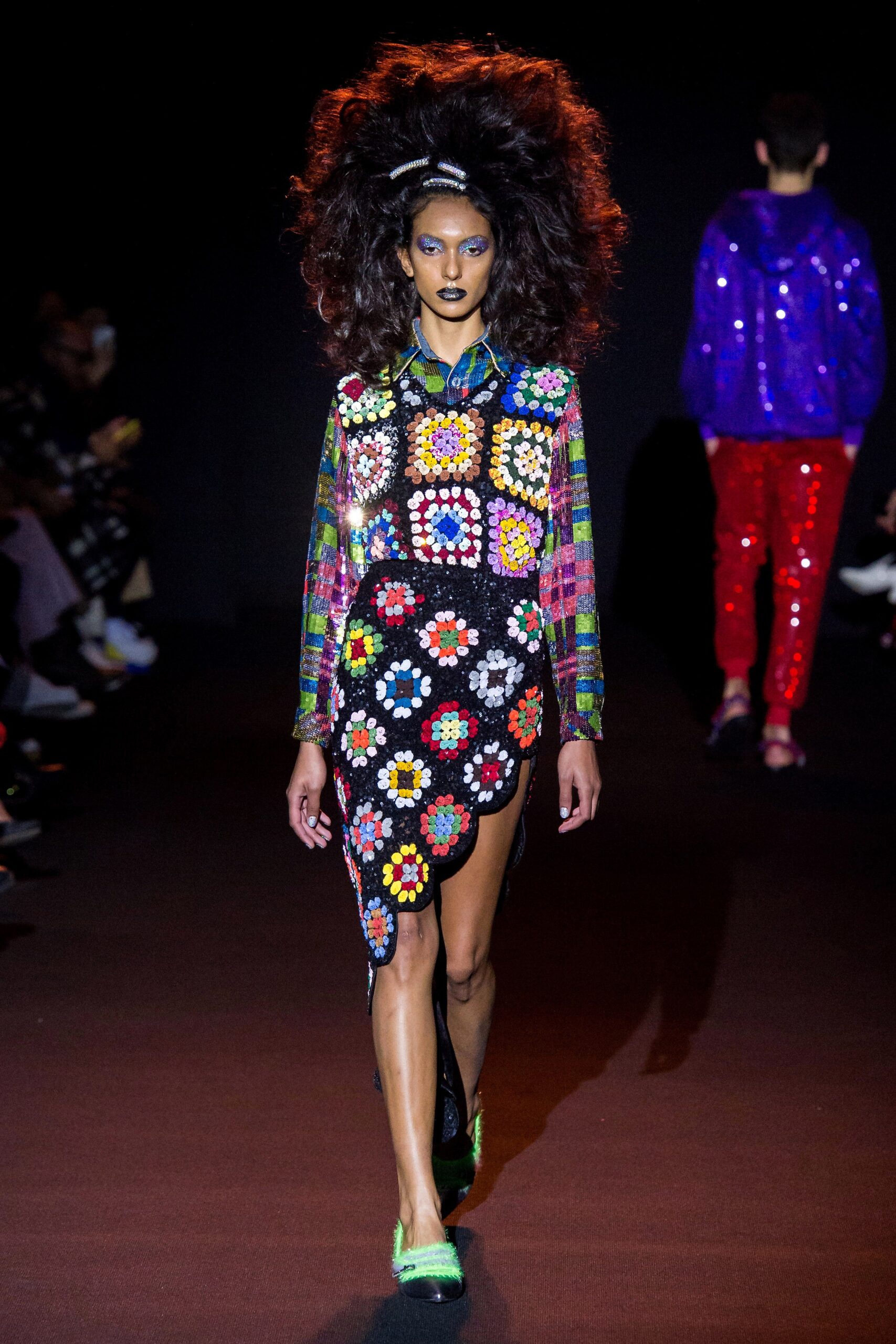 multi-colored embroidered shirt and black flared skirt
