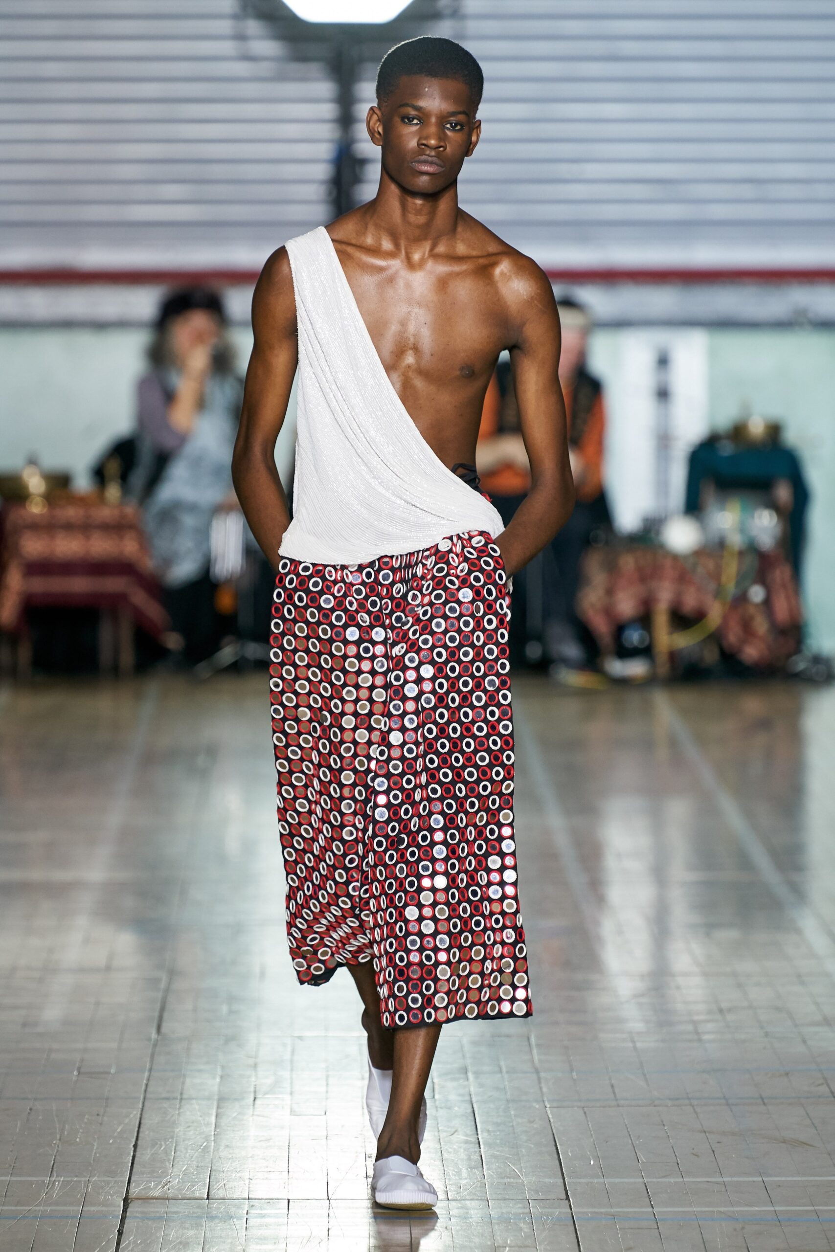 white asymmetric top with printed pants