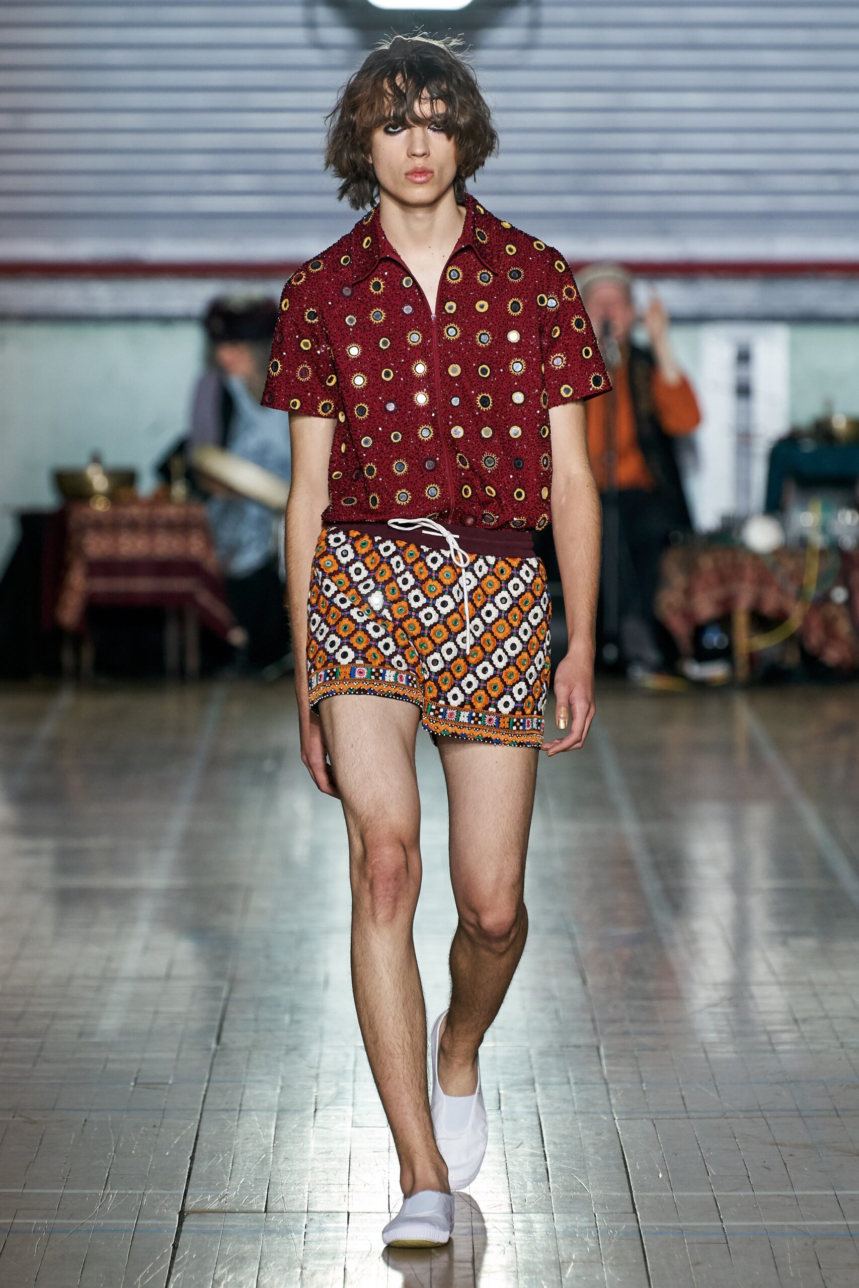 red printed shirt and orange shorts