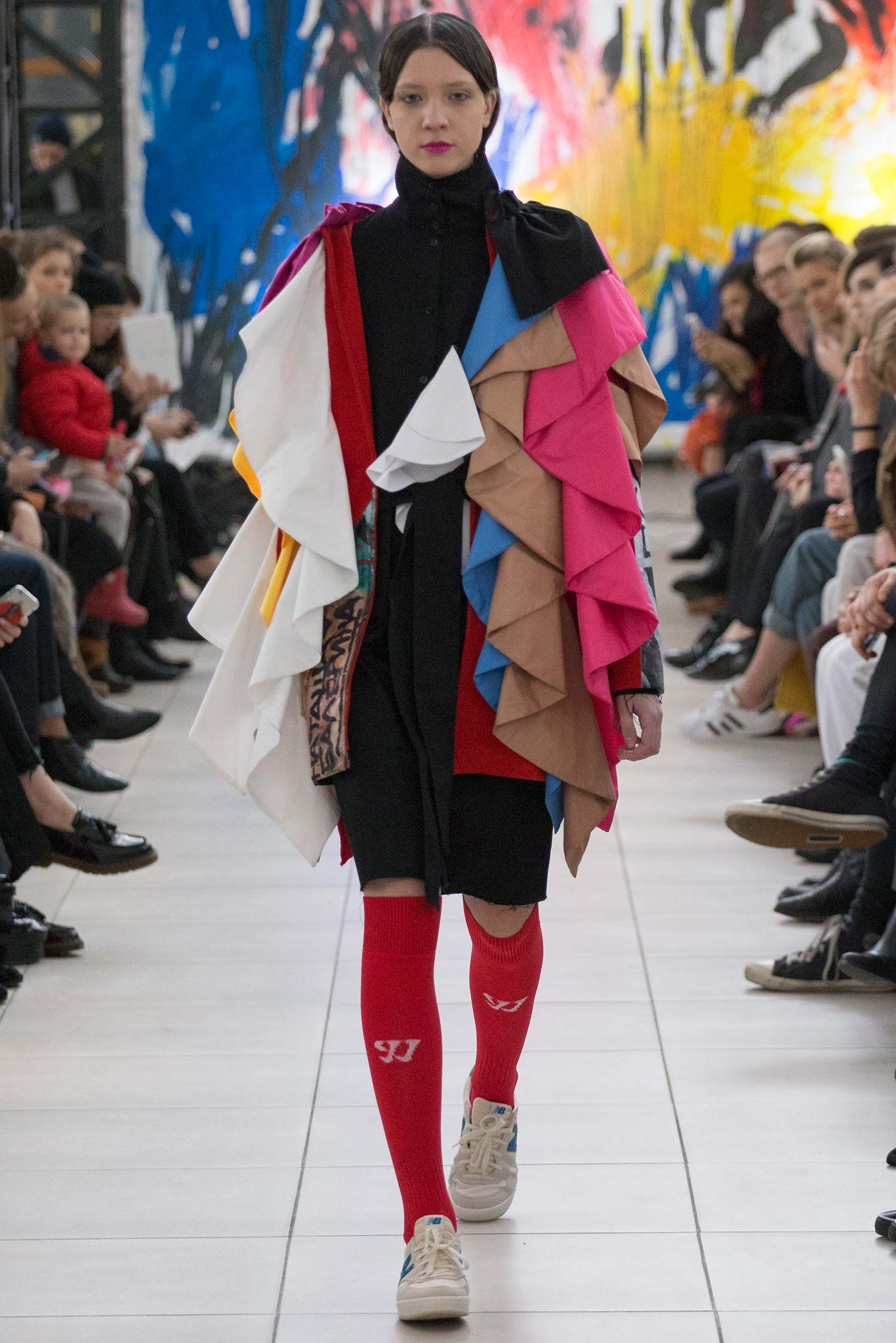 black fitted mini dress with layered cape