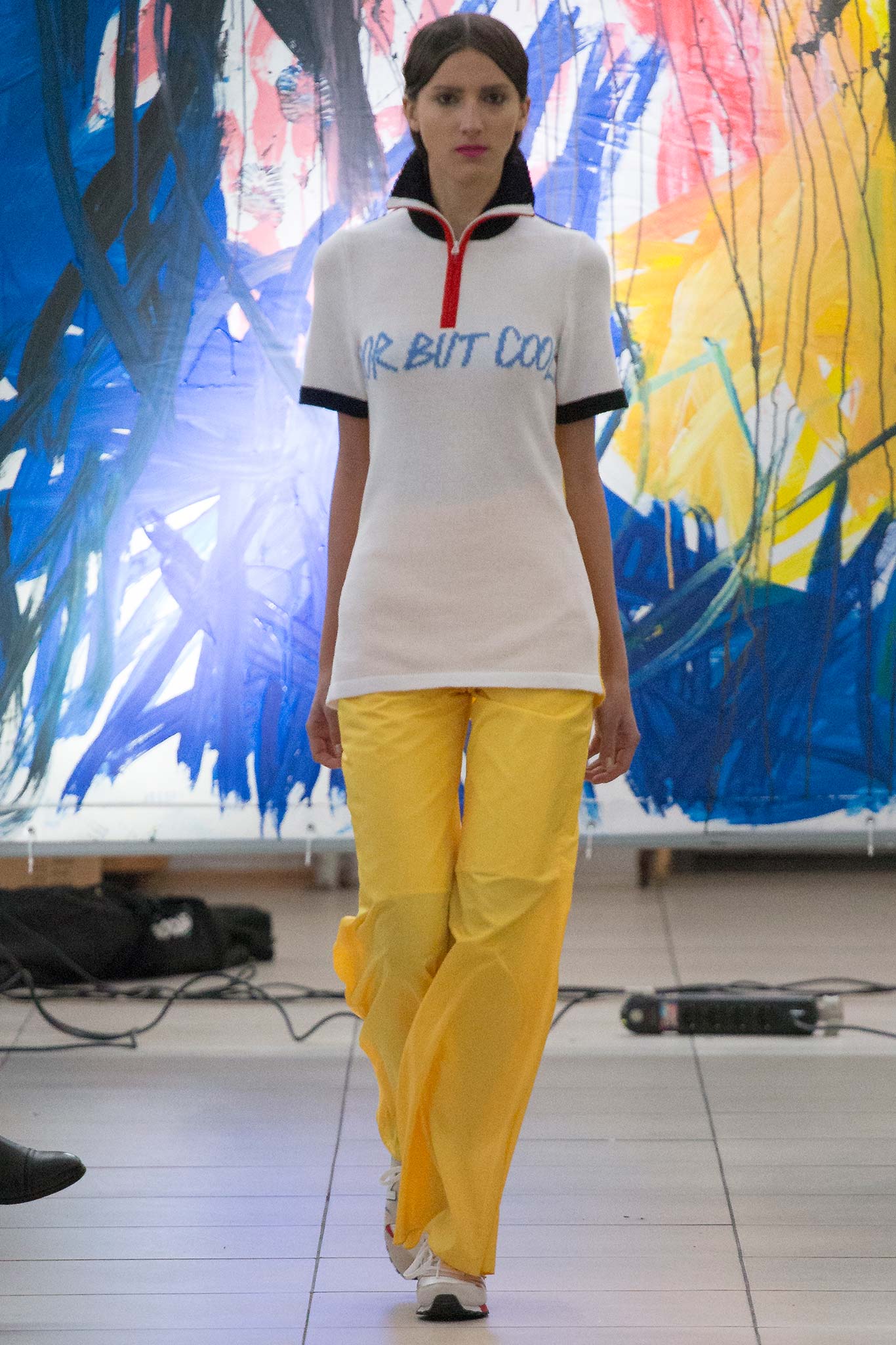 fitted white top with printed text and relaxed yellow pants