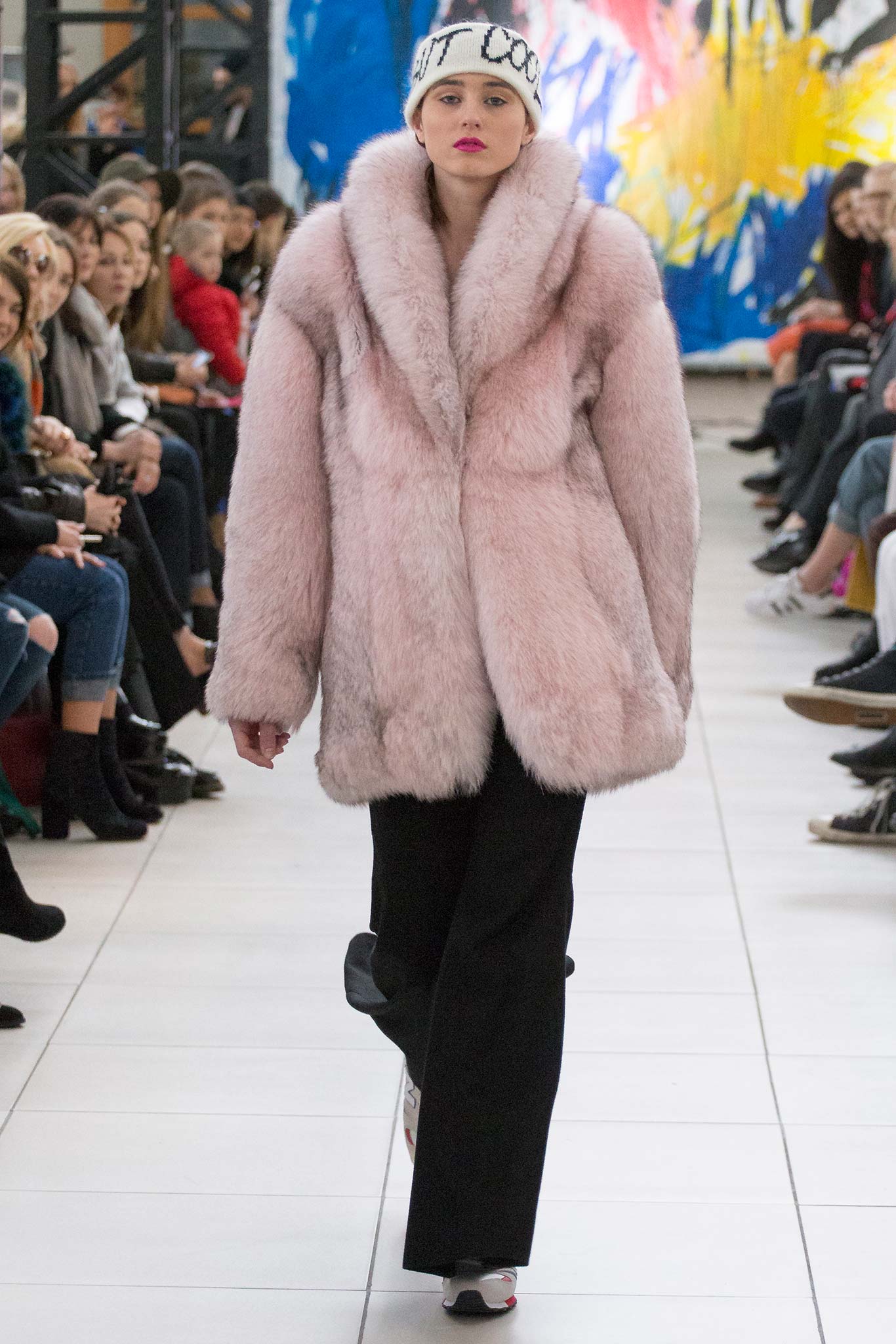 pink faux-fur coat with black pants