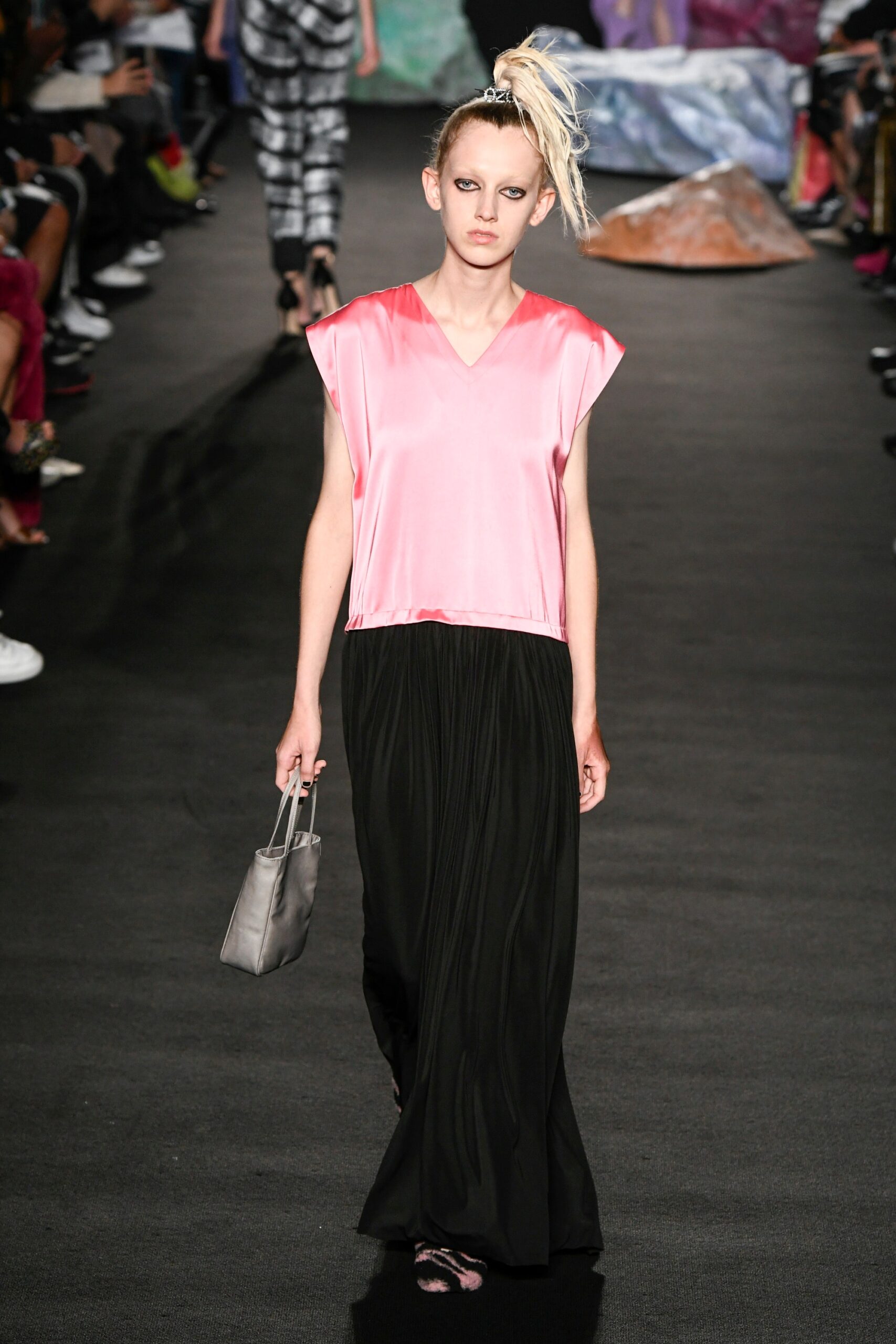 pink silk top with black pleated skirt