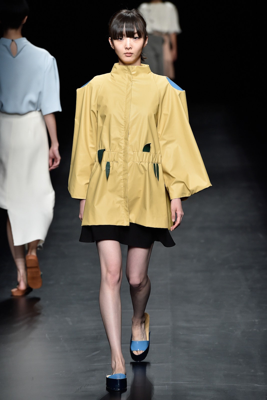 yellow vinyl coat with black dress