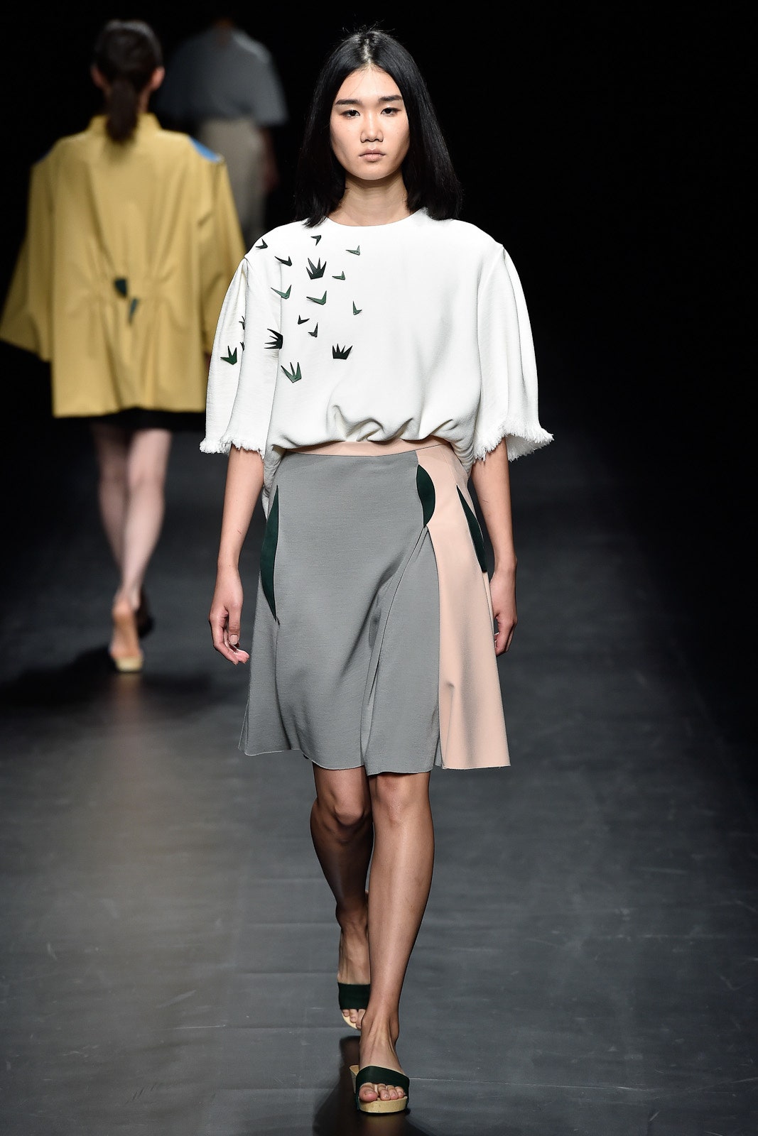 relaxed white top with asymmetric gray skirt