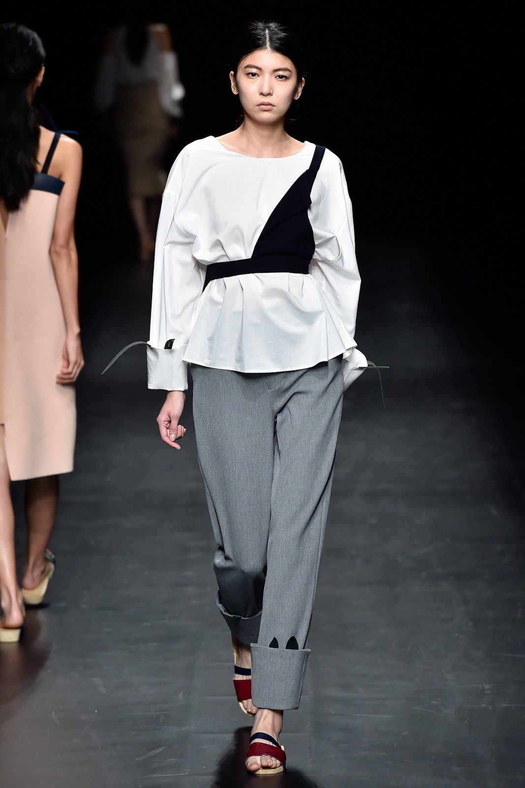 white top gray pants red shoes