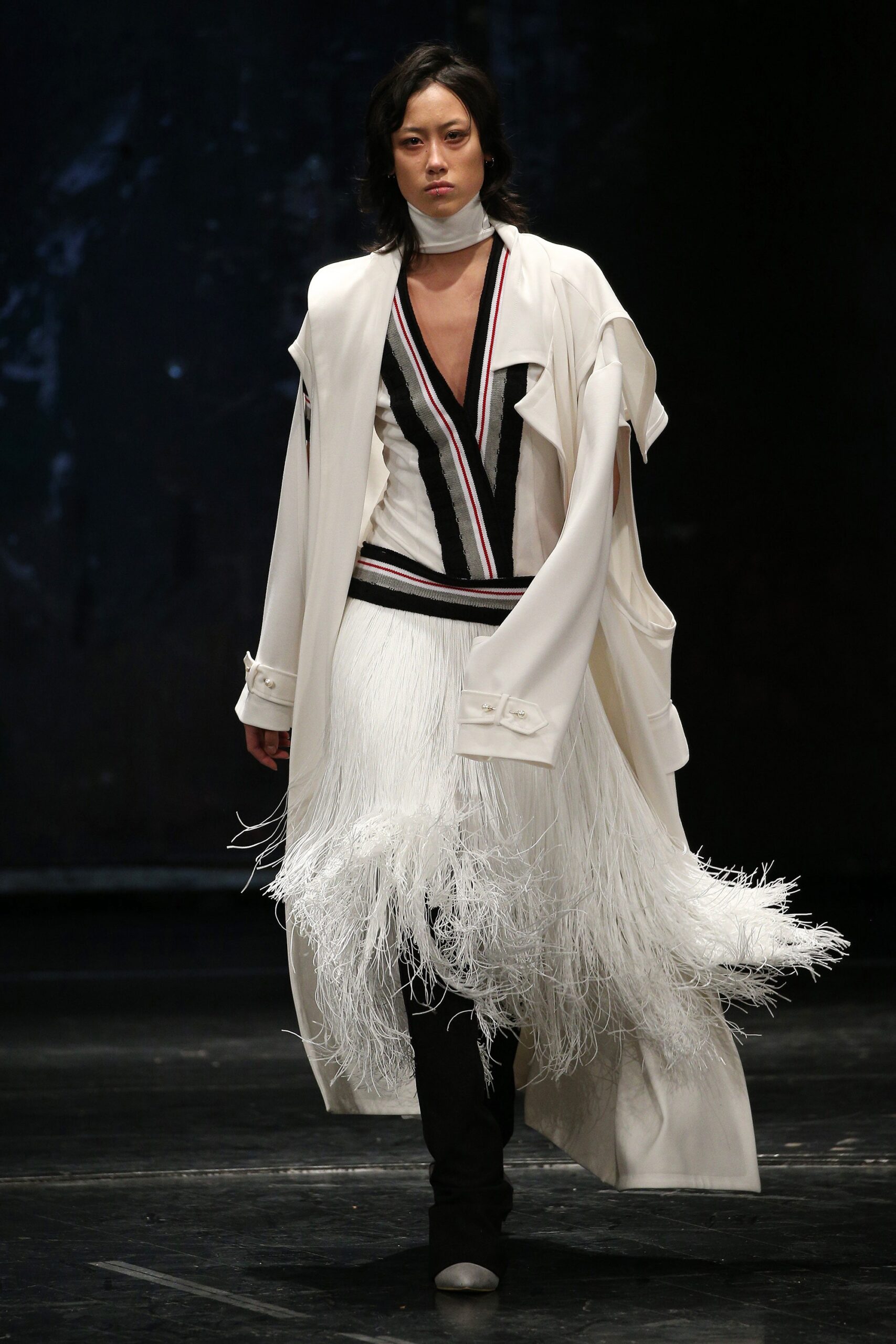 white oversized coat and black fringed dress