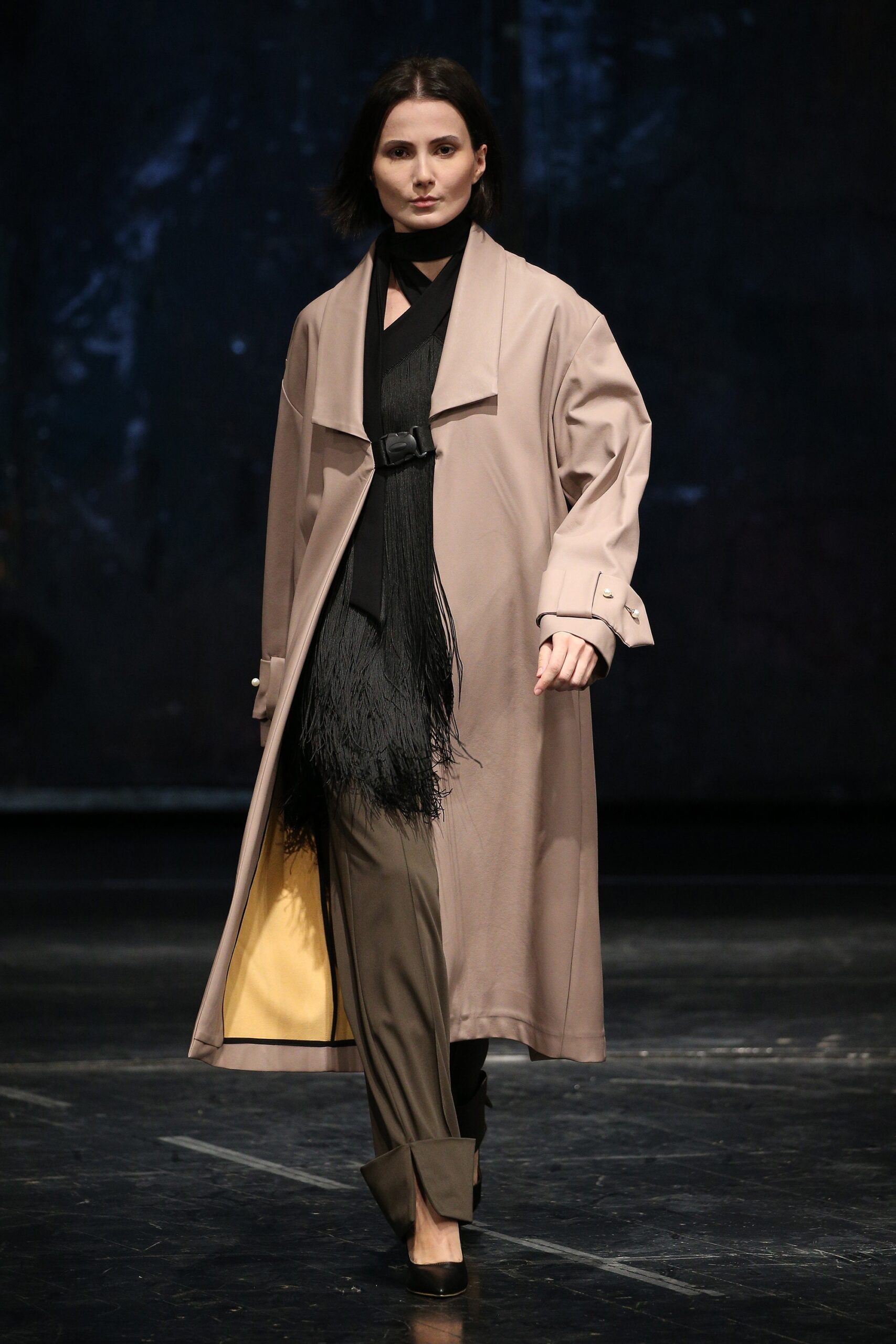 beige coat black top gray pants