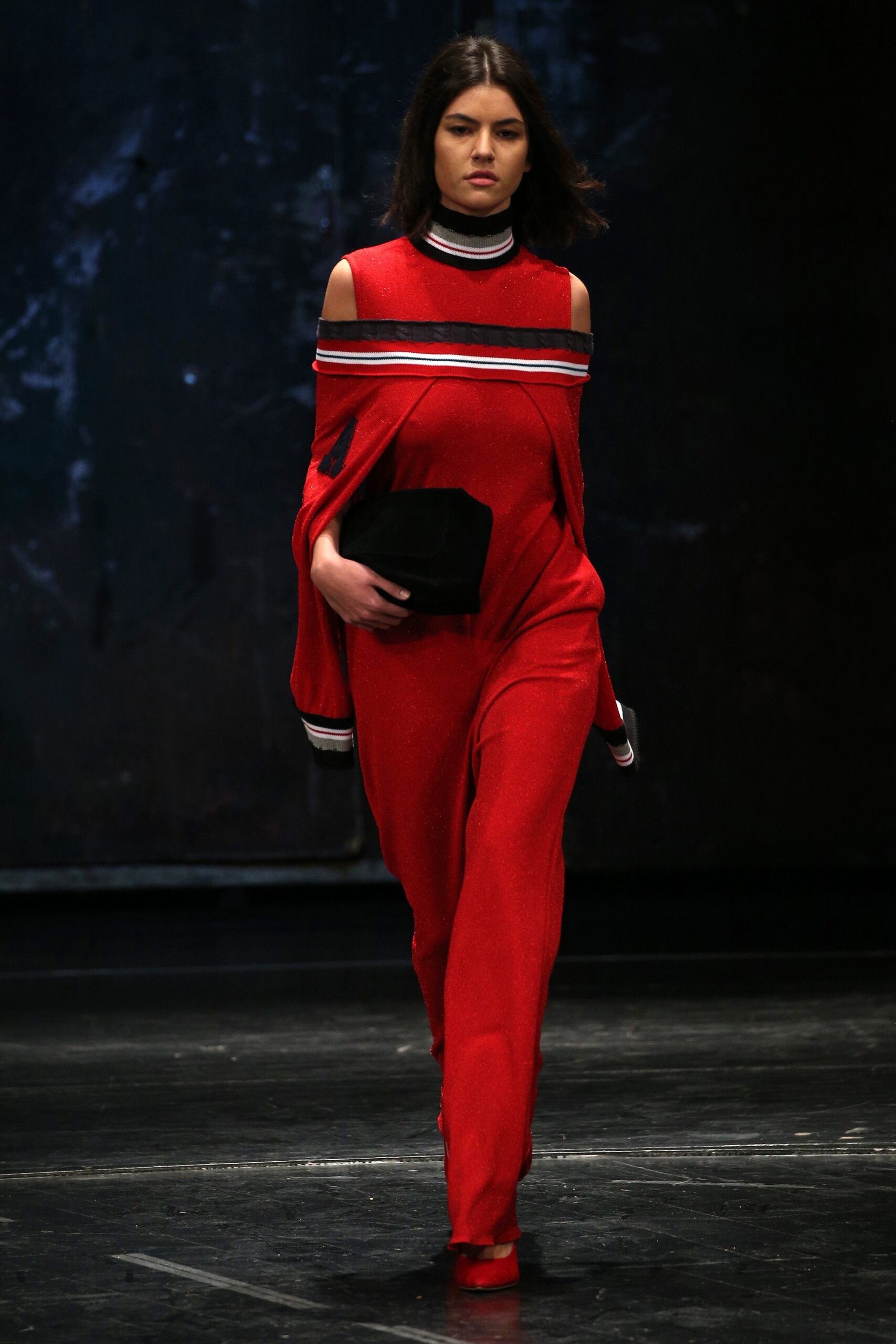 red off-shoulder jumpsuit with clutch