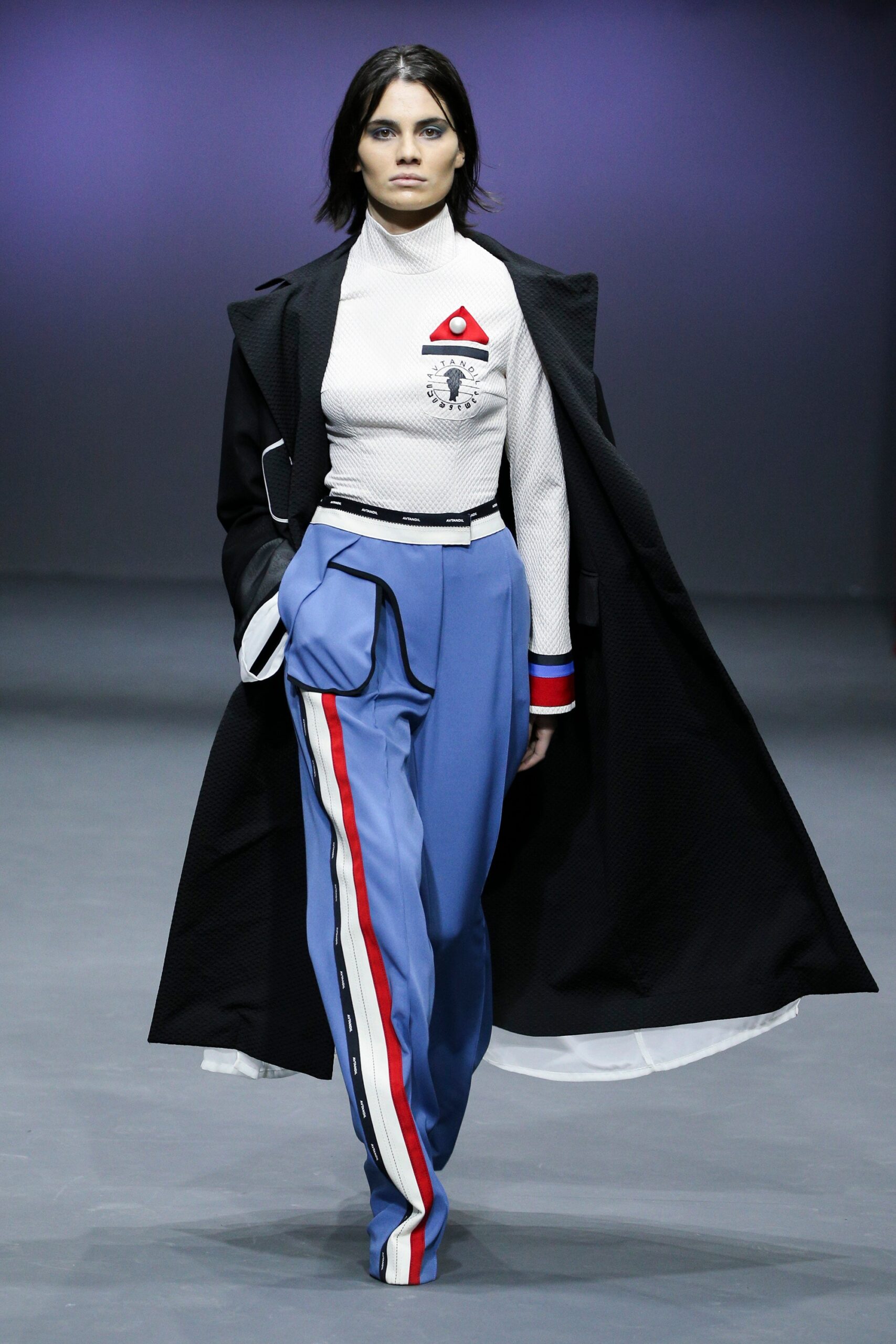 black coat white top blue pants