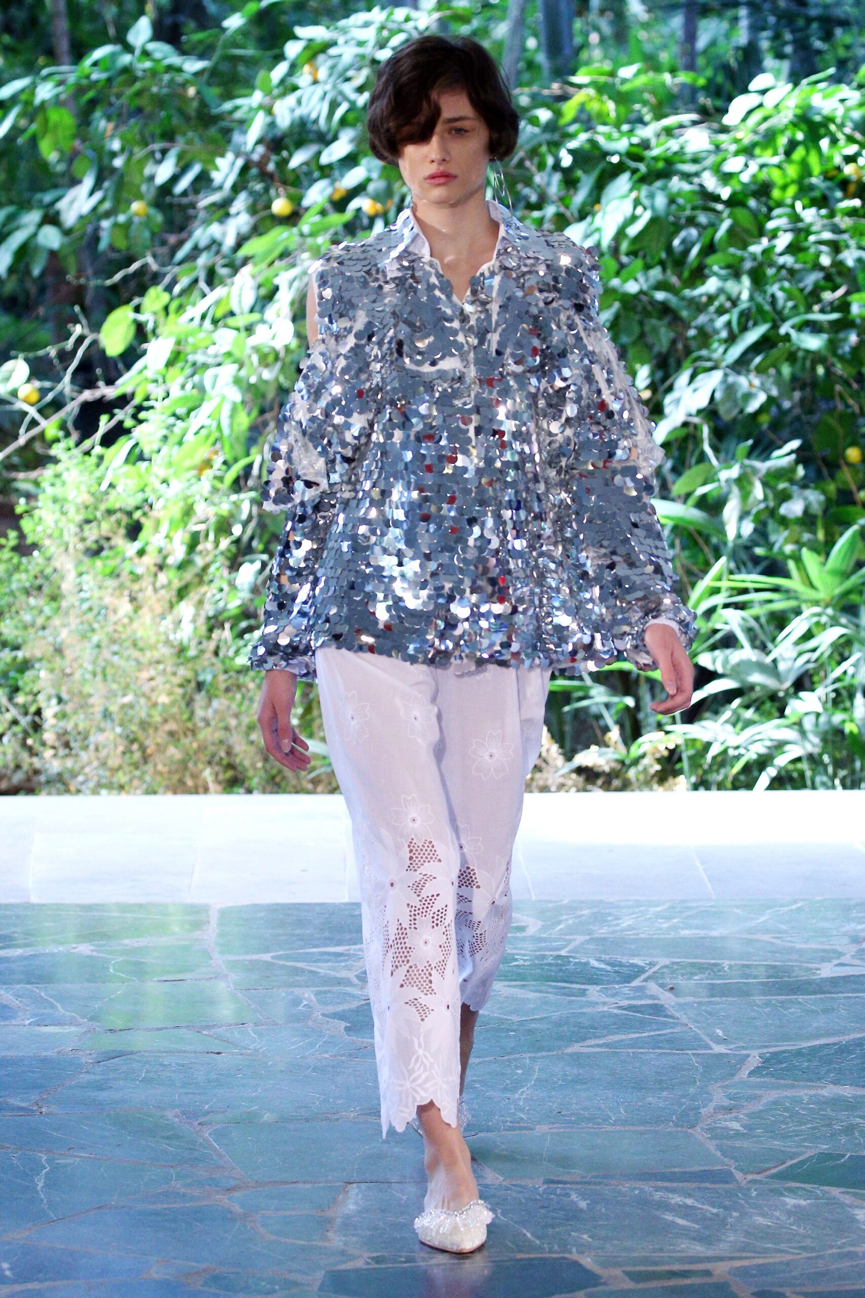 silver ruffled top with white pants