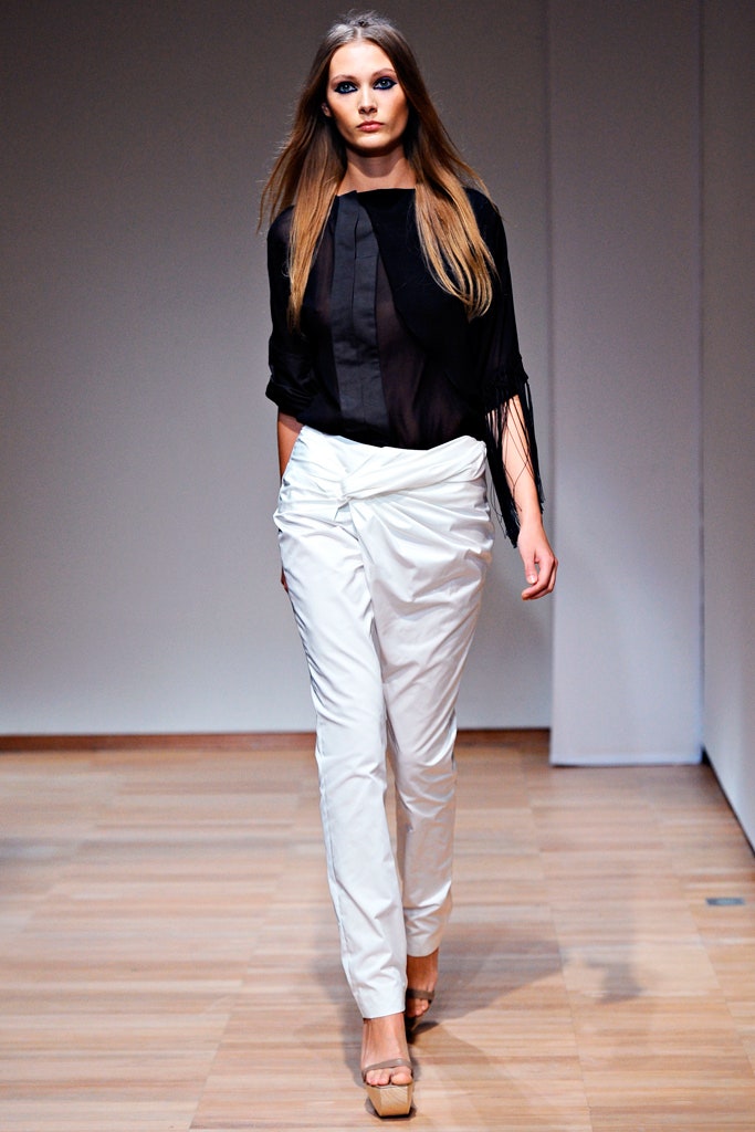 black silk top with fringes and white pants