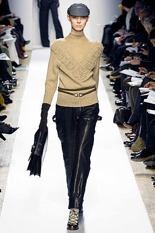 beige fitted sweater with black leather pants