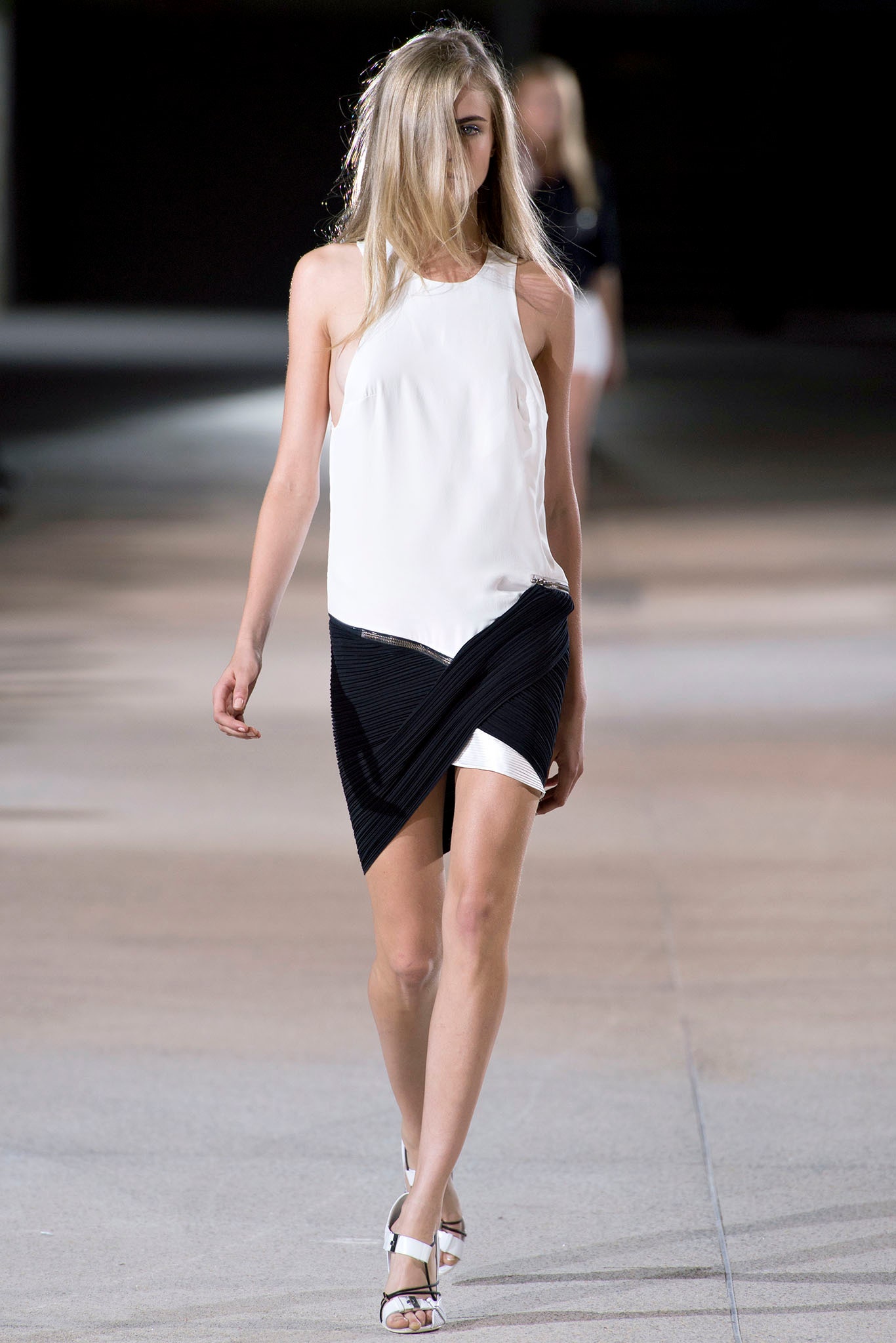 white silk sleeveless top and black asymmetric skirt