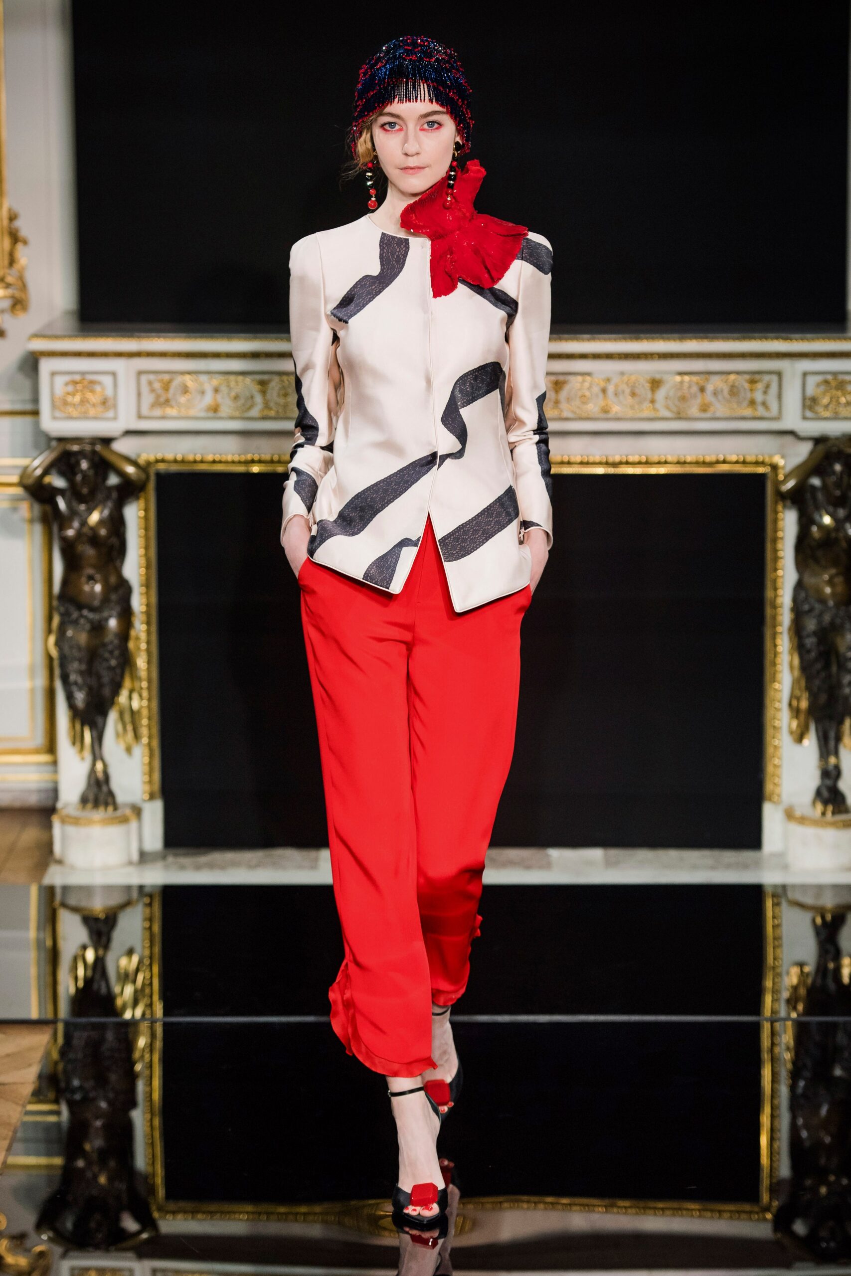 beige asymmetric blazer with red pants