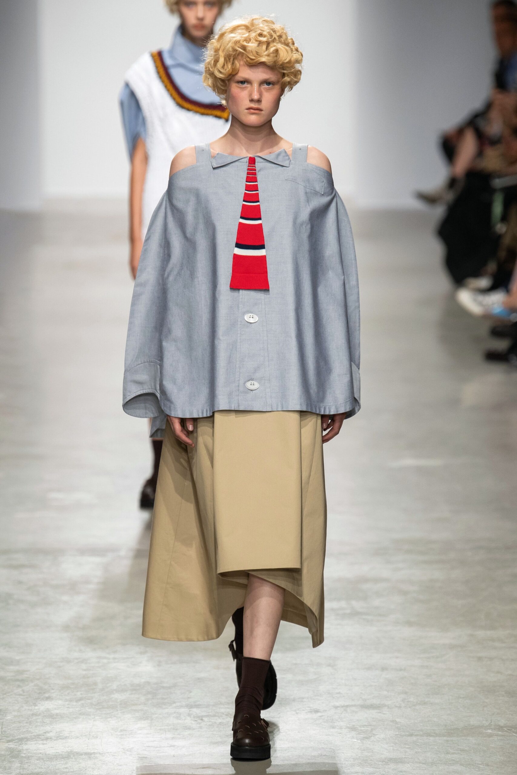 oversized blue top with beige skirt
