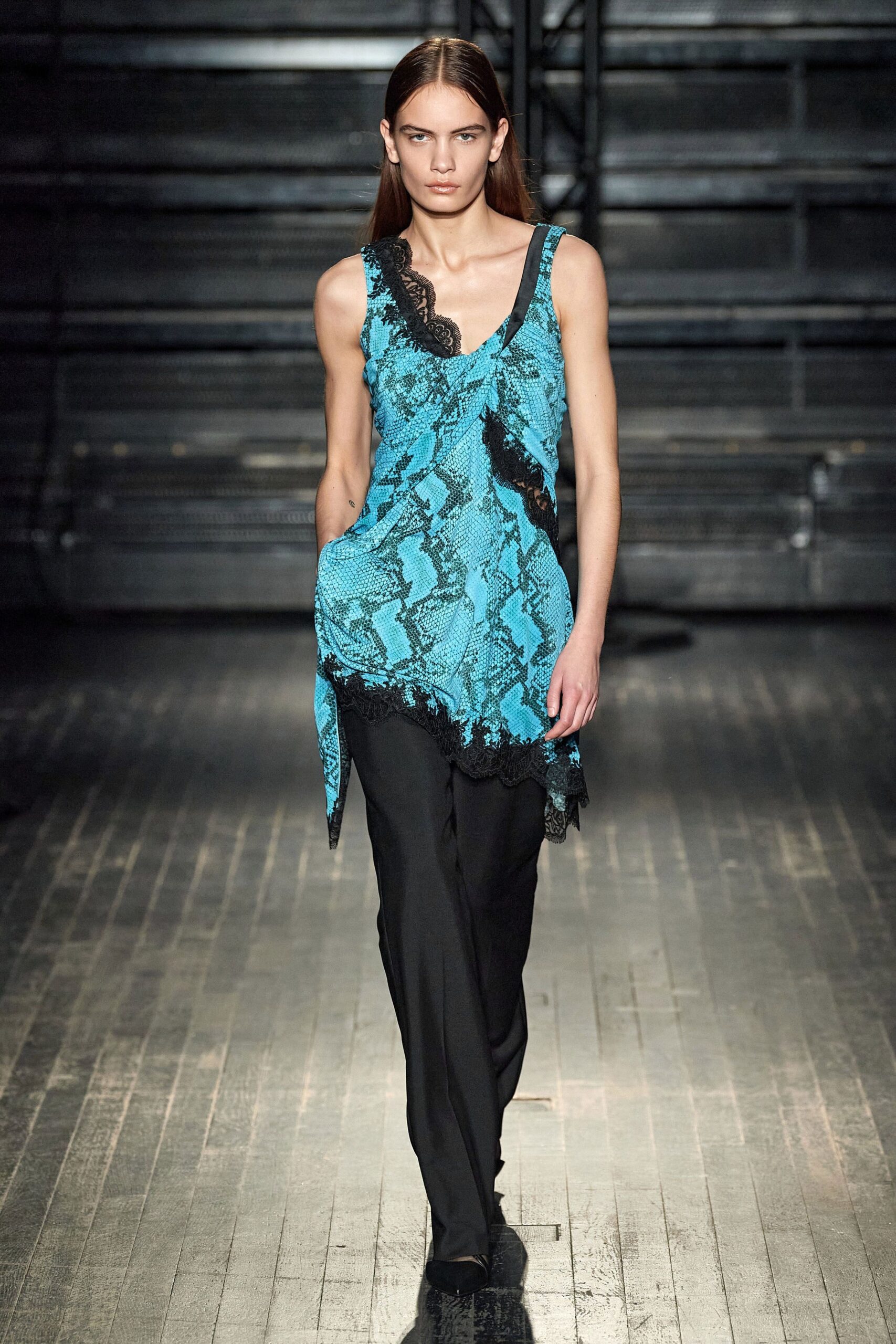 blue silk sleeveless top with black pants