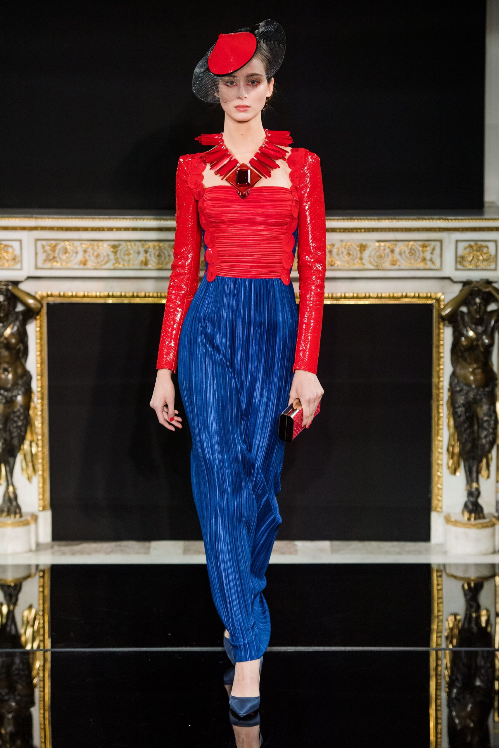 red sequined top with blue pants