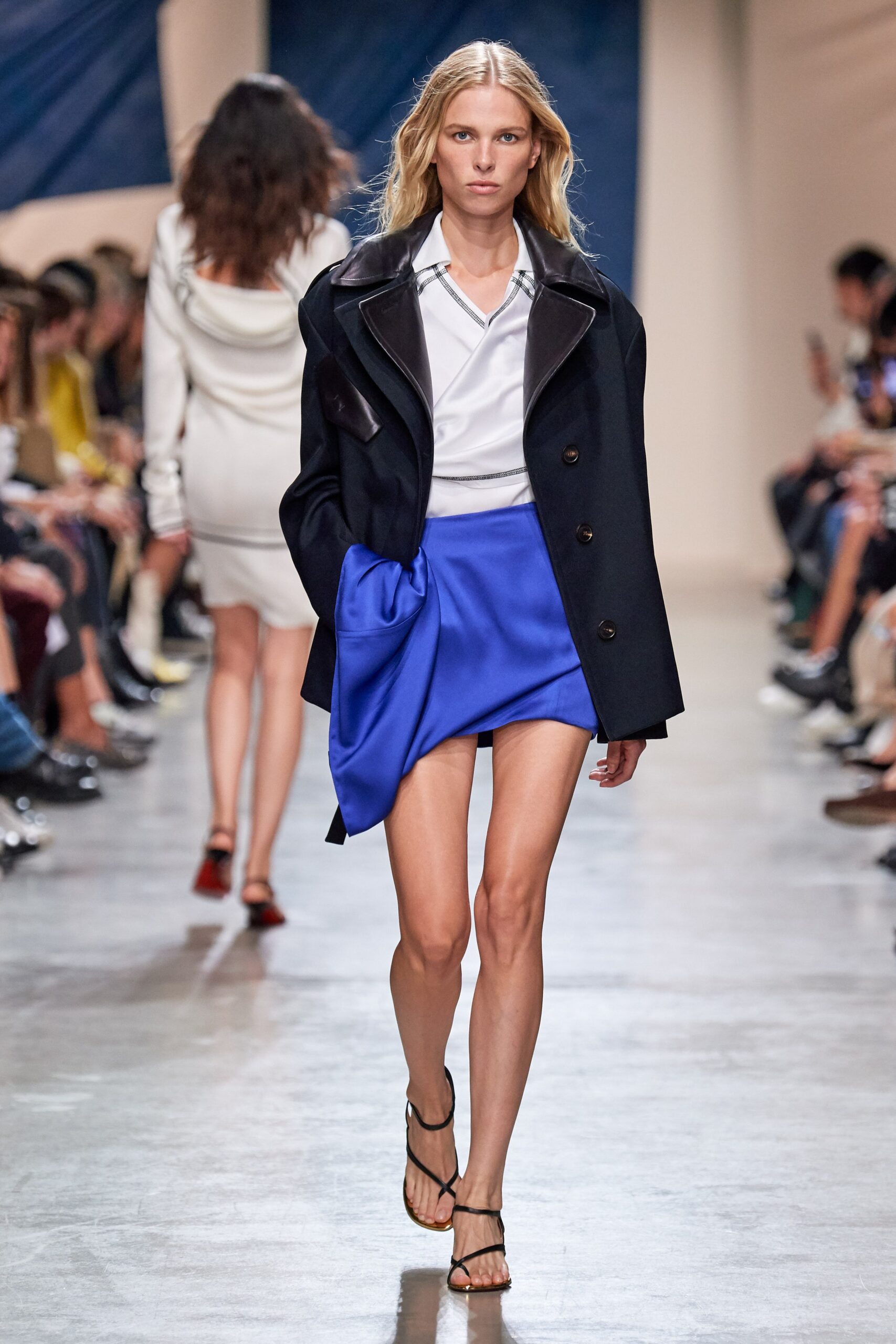 black coat white shirt blue skirt