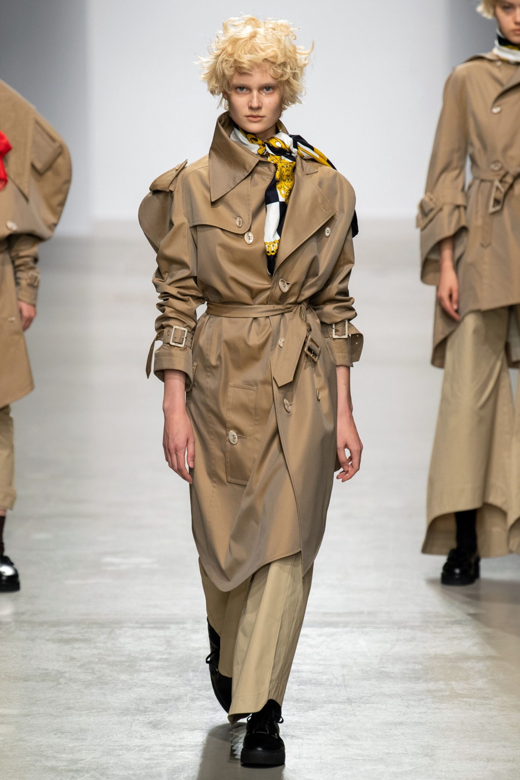 beige fitted trench coat and relaxed pants