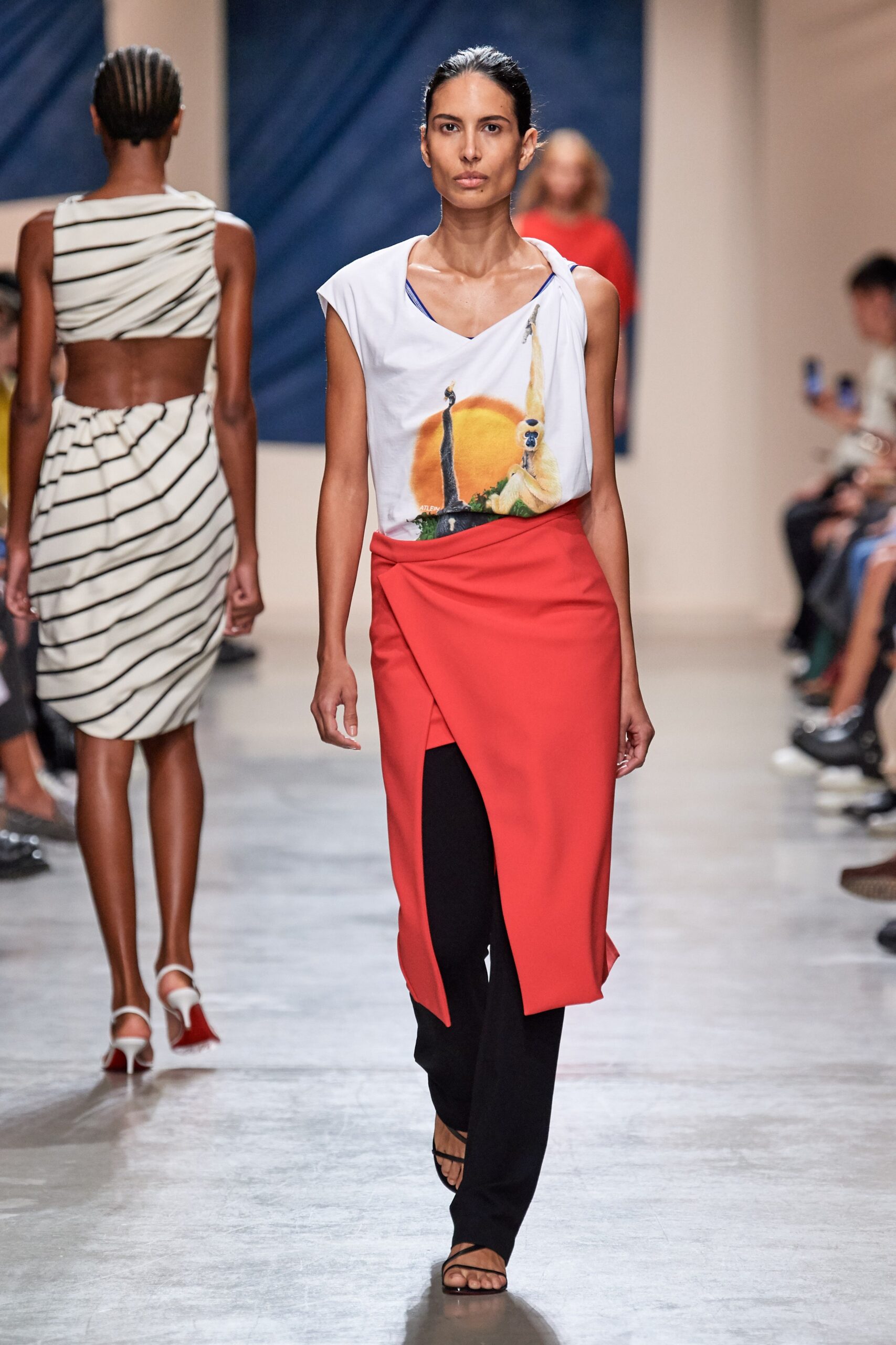 relaxed printed top with red skirt