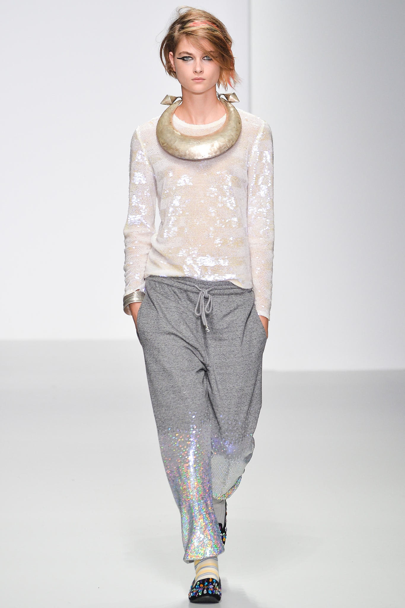 white sequined relaxed top with gray pants
