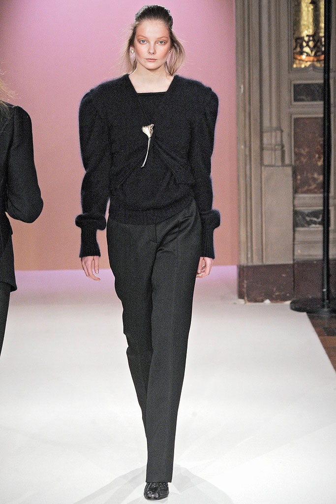 black fitted sweater and tailored pants