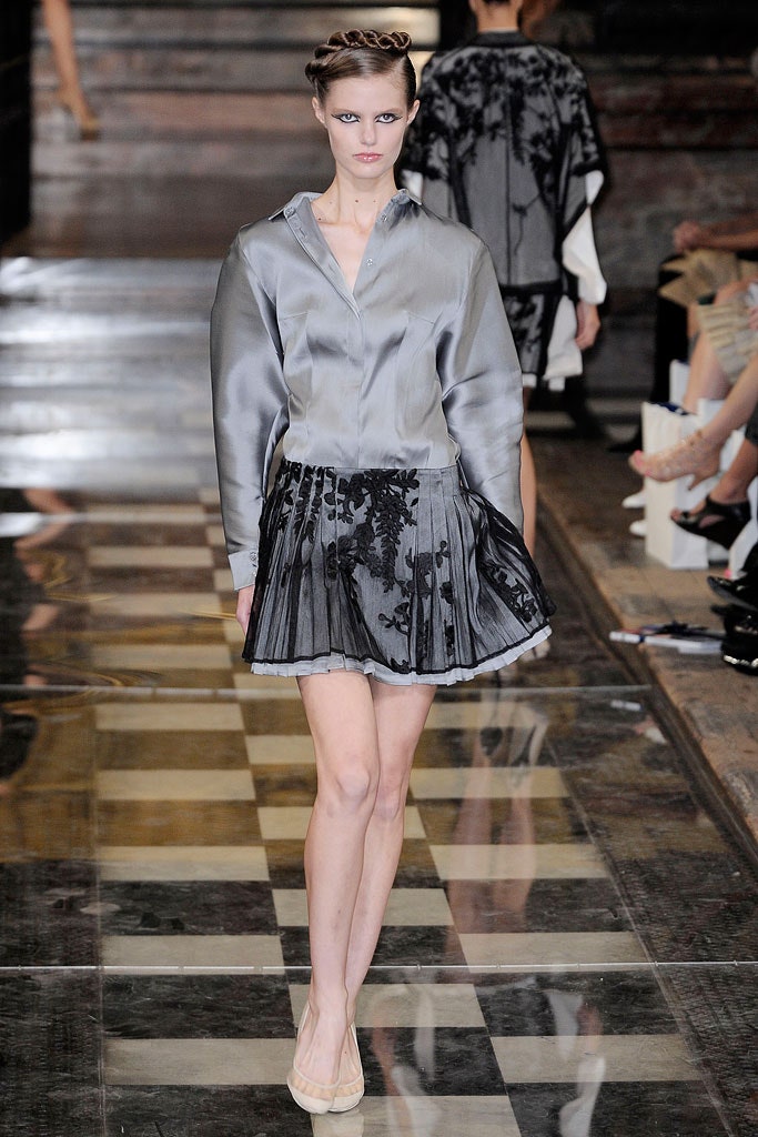 gray silk shirt and black pleated skirt