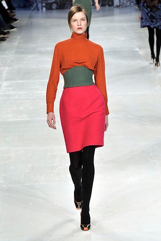 orange fitted top with pink pencil skirt