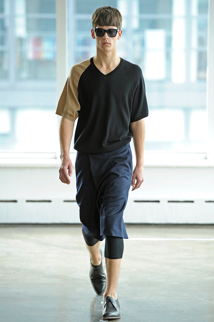 black and brown relaxed top with blue pants