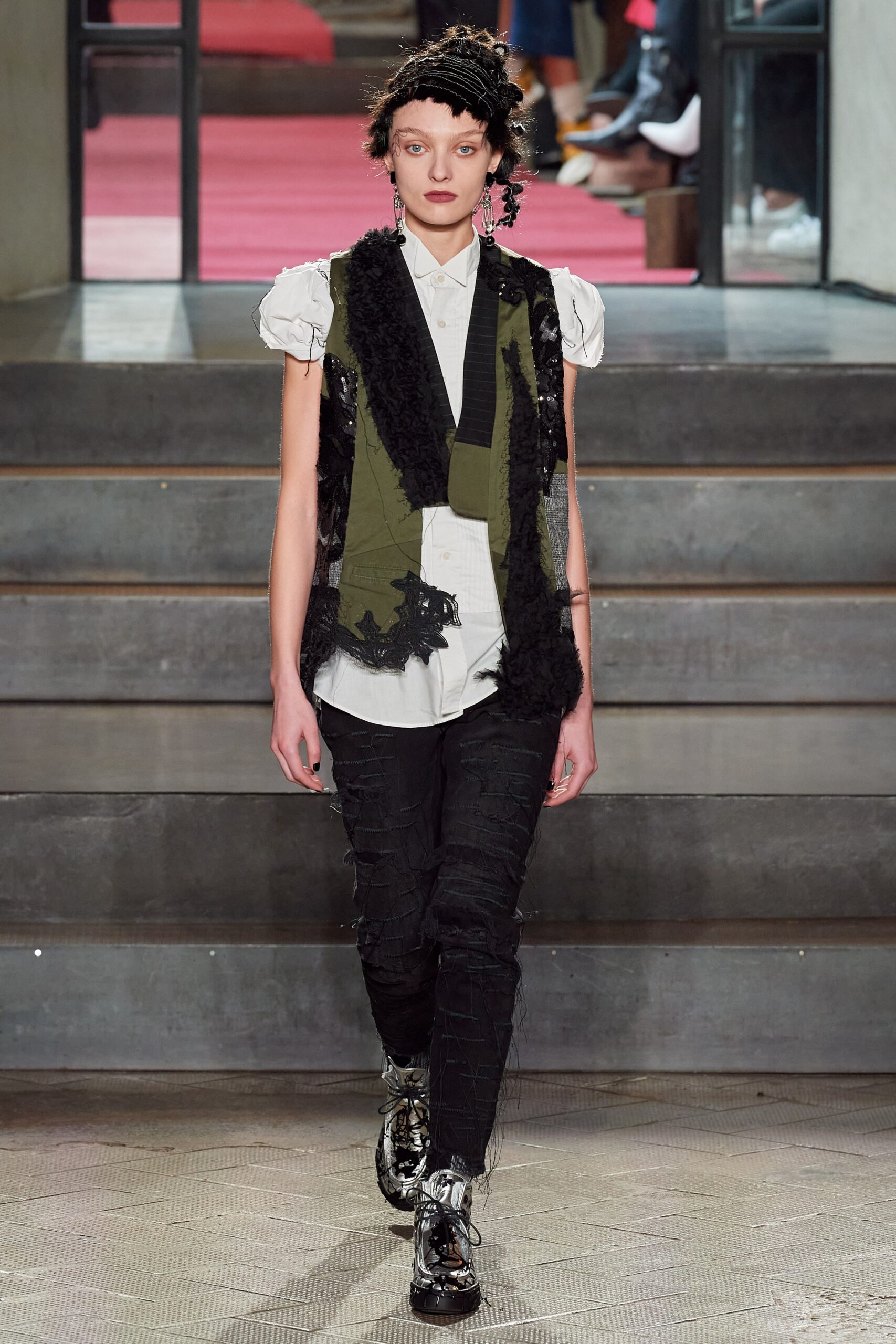 green black fringed vest with white shirt