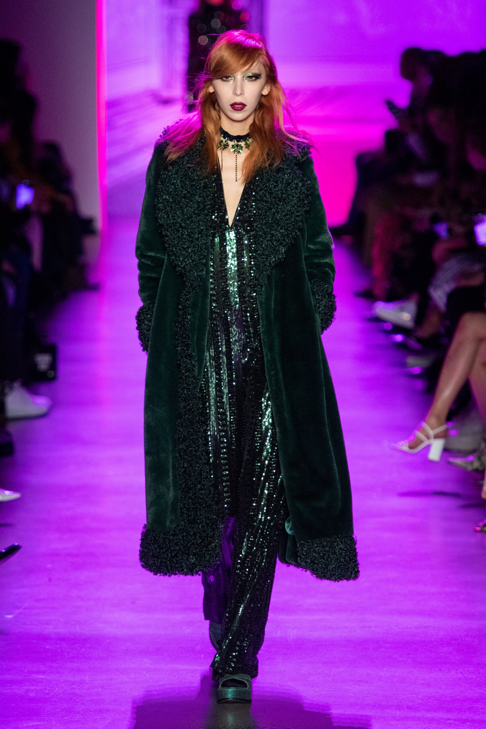 green faux-fur coat with black sequin jumpsuit